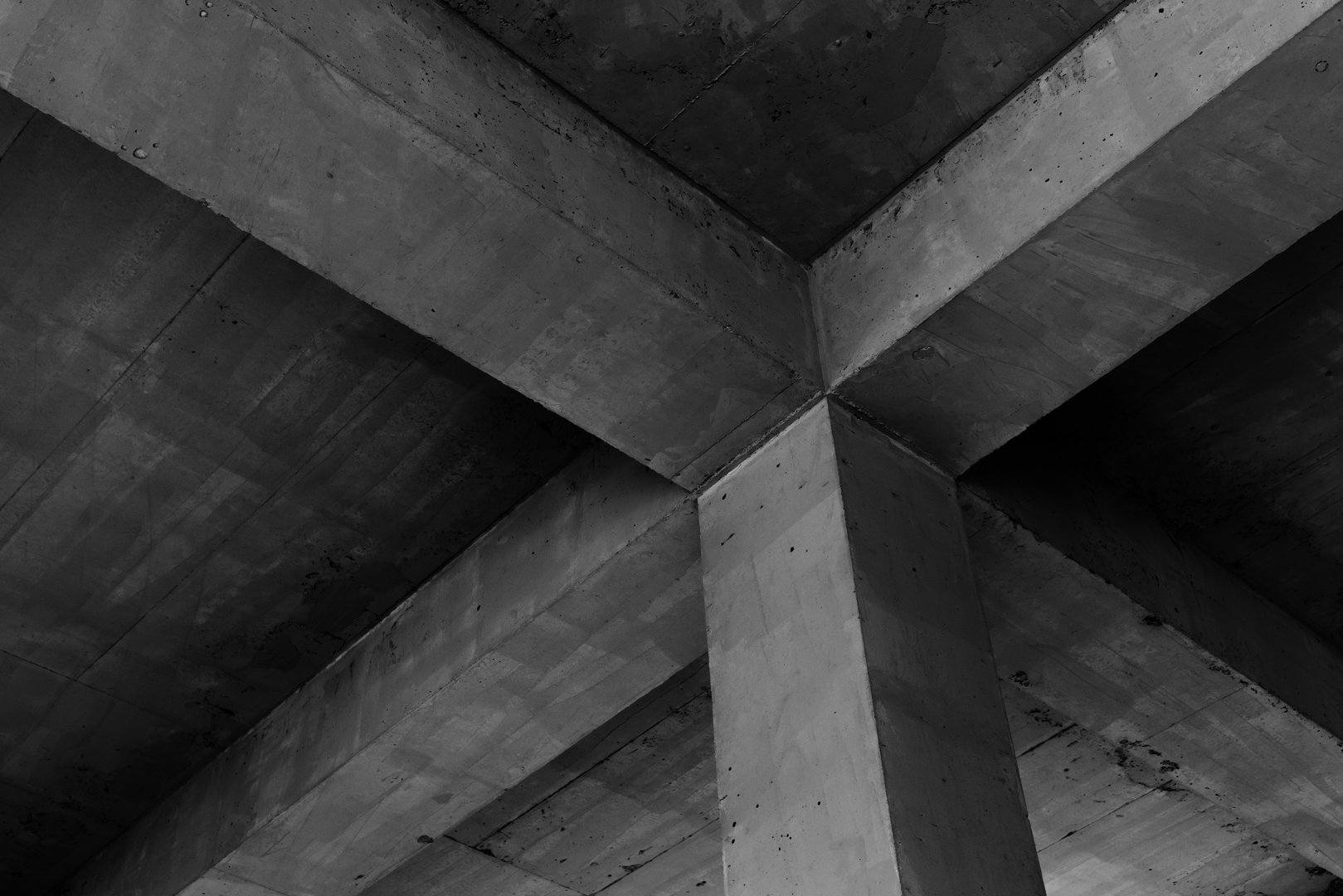 Abstract dark concrete construction background, ceiling with girders and square pillar