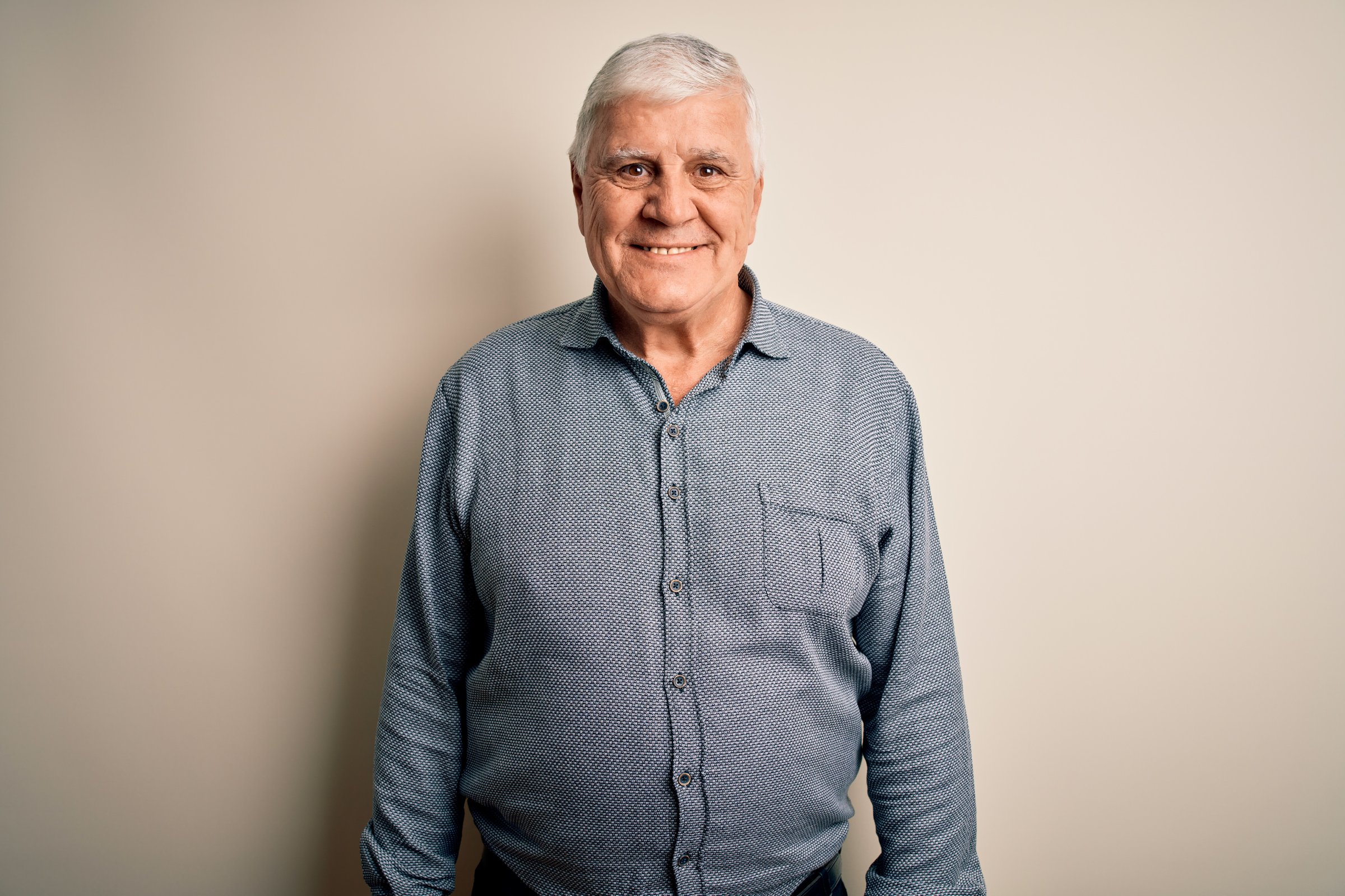 Senior handsome hoary man wearing casual shirt standing over isolated white background with a happy and cool smile on face. Lucky person.