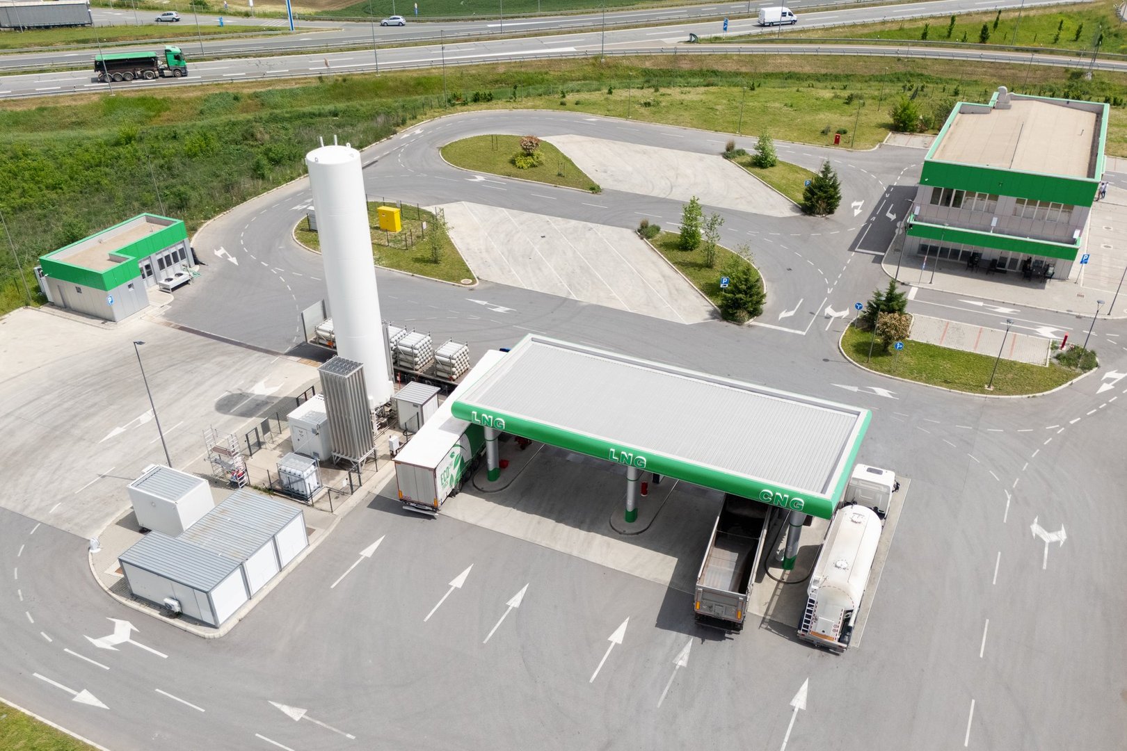 CNG and LPG fueled trucks at a gas station. Aerial view. Drone point of view