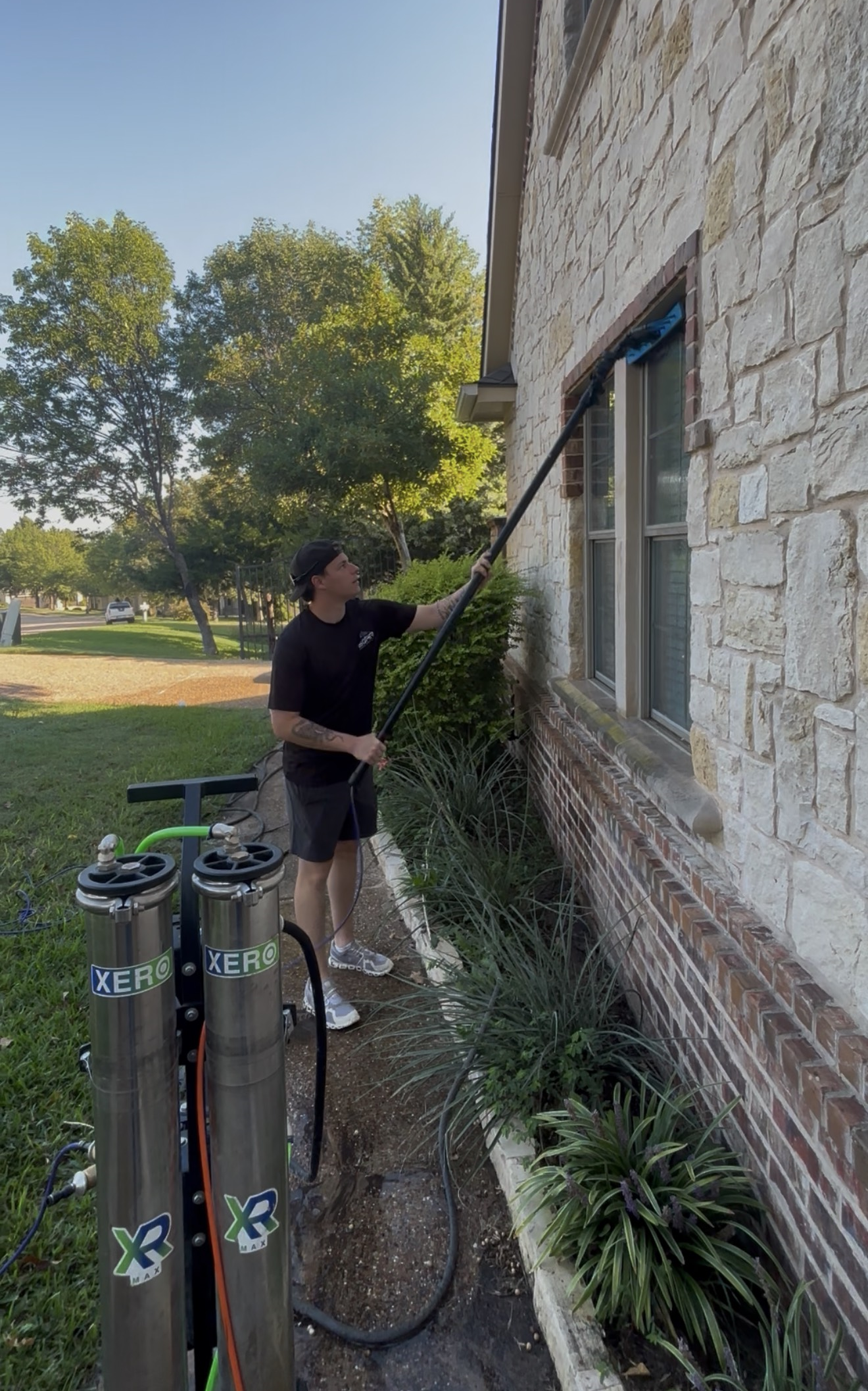 Tyler cleaning windows at Soar Home Services in DFW