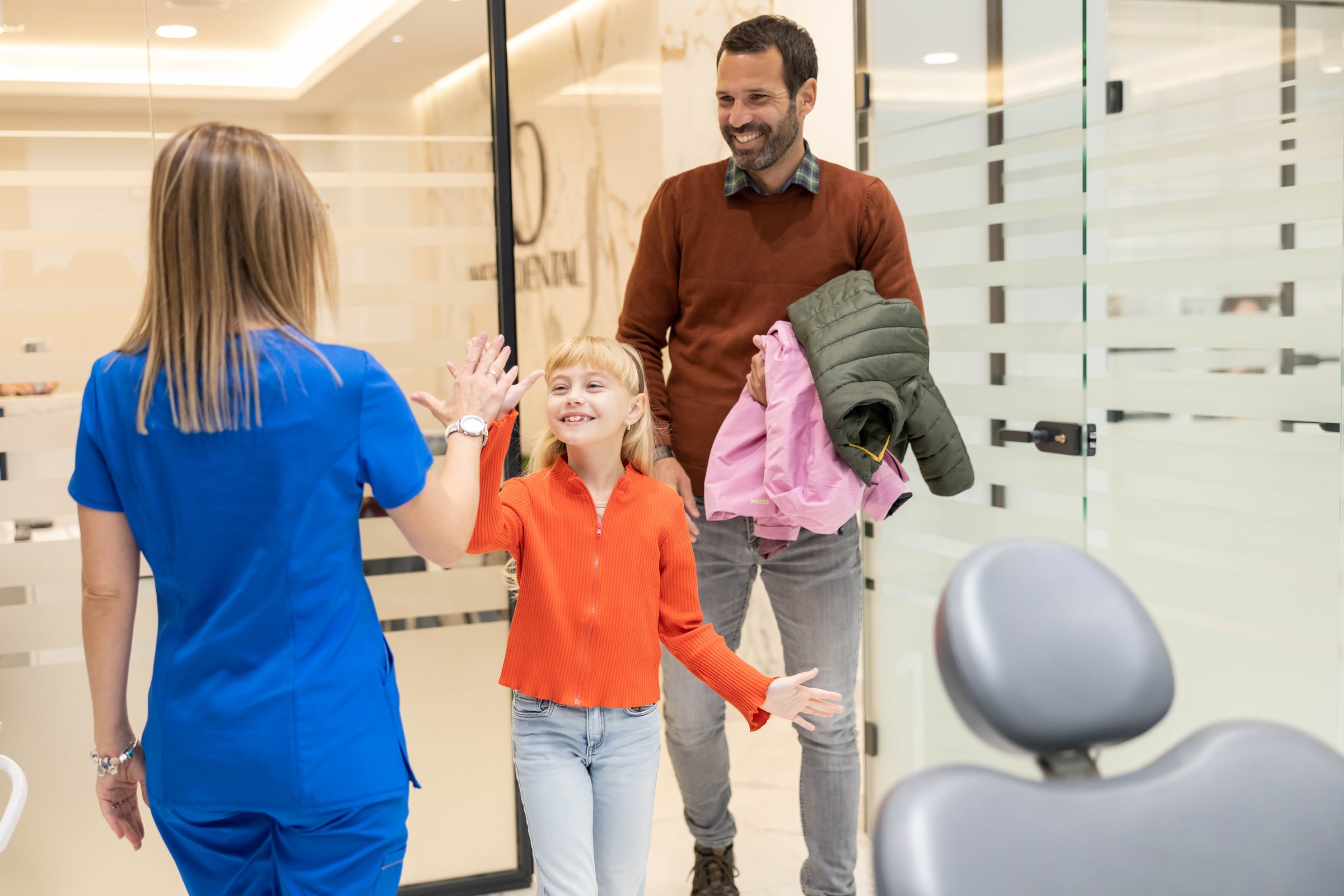Happy child celebrating successful dental visit with gentle dentist at children-friendly dental clinic in Labrador