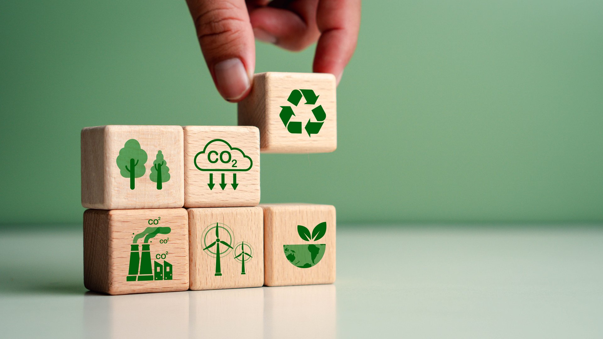 Carbon footprint reduction concept with wooden cubes
