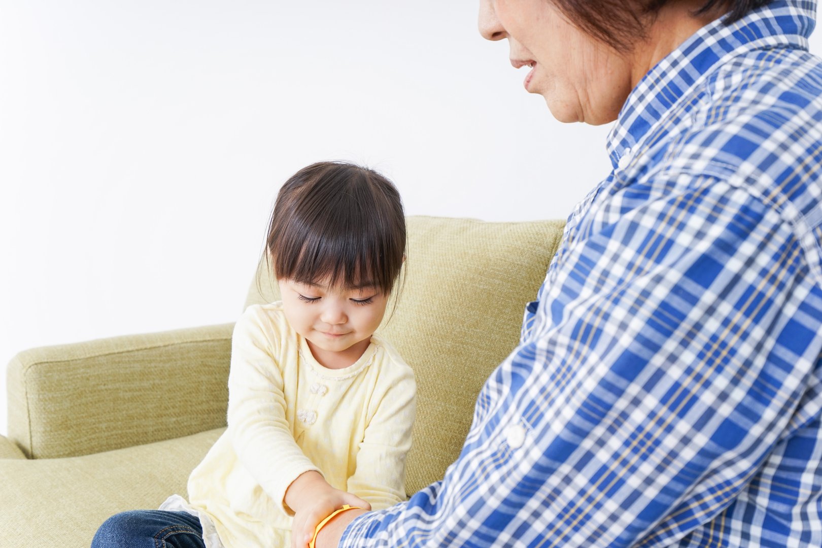Child playing with grandmother in room