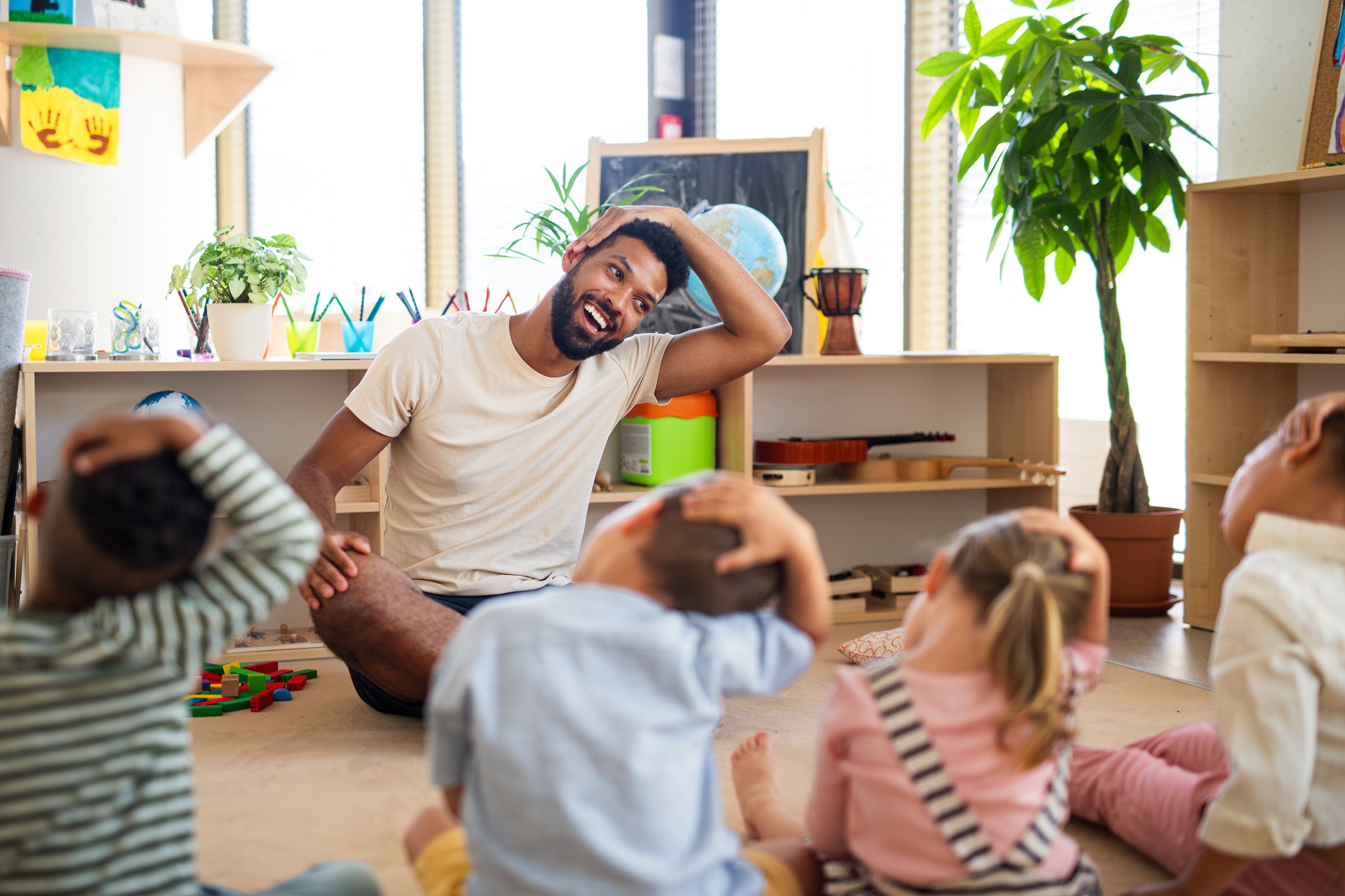 Nursery school children with teacher learning together