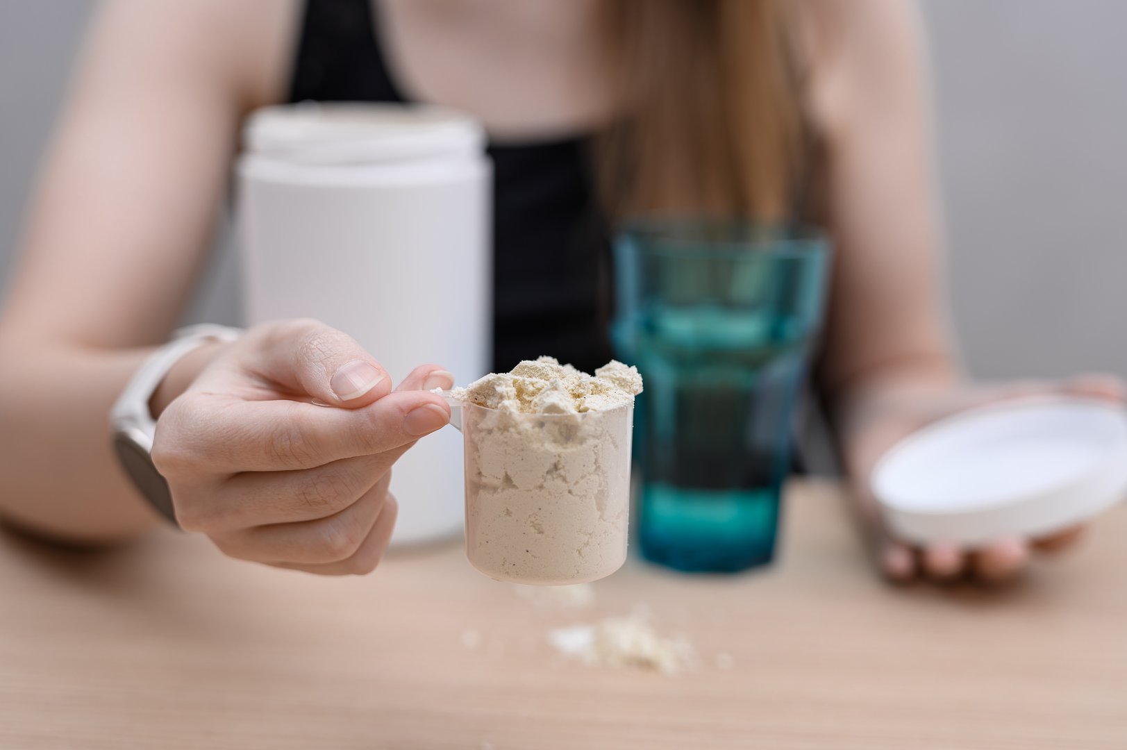 Supplements for training. Protein supplement, WPC isolate powder in a measuring cup for dissolving in water.