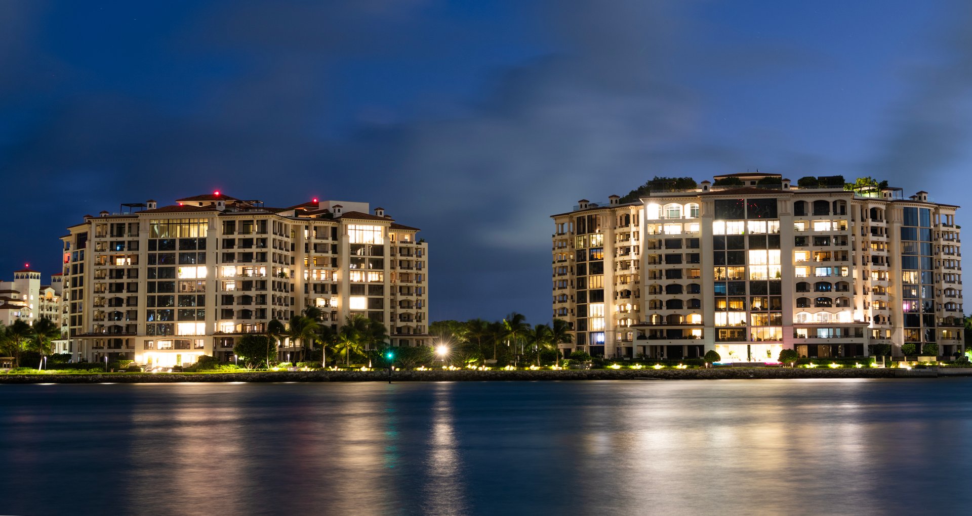 Miami beach with waterfront architecture. Miami residential building, Florida. Fisher island. Travel destination. Fisher island night view. Night aerial view of Fisher island, Miami. Luxury life.
