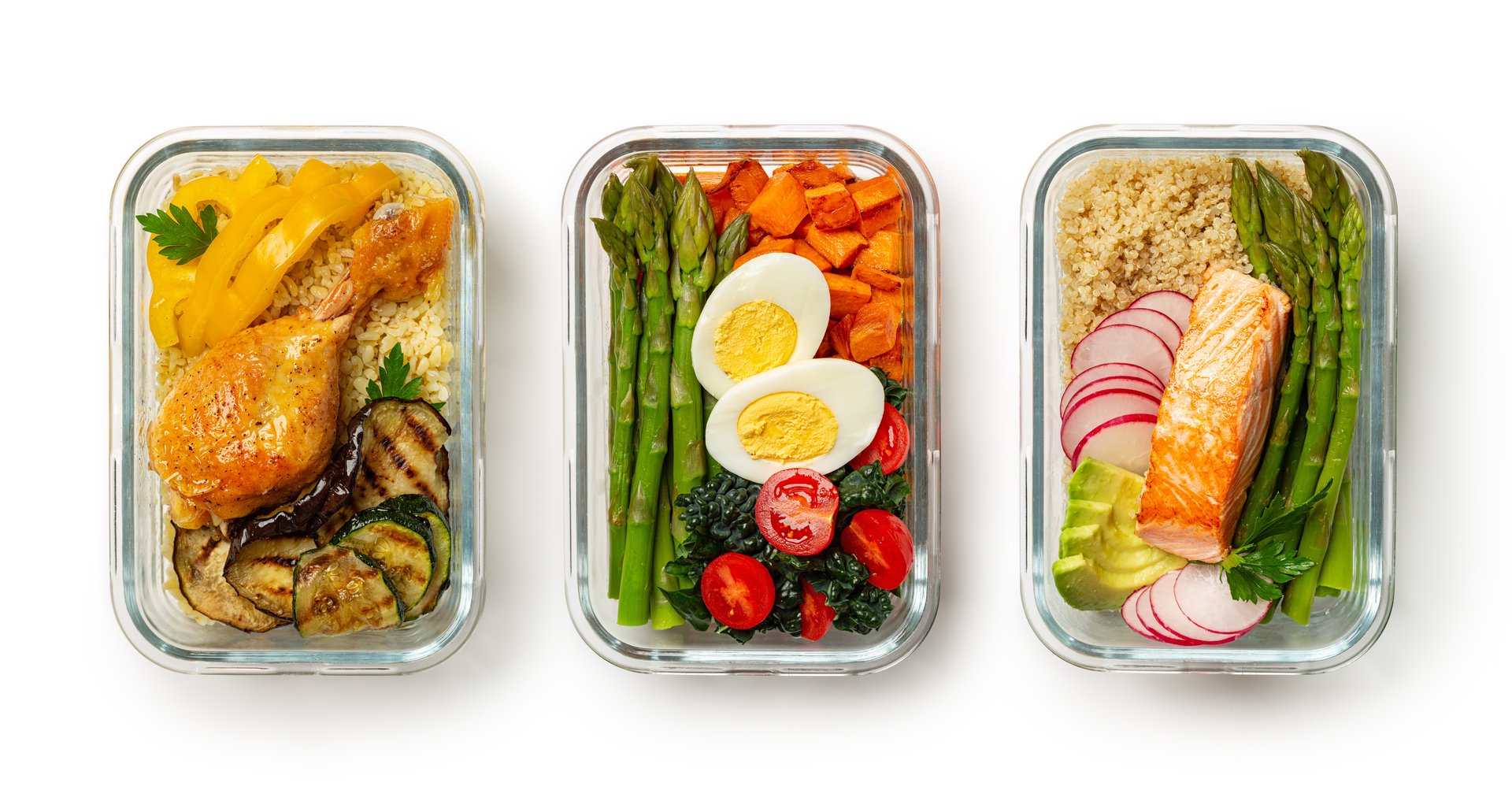 Healthy meal prep ideas, containers, lunchboxes with variety of trendy food, salmon fish with quinoa and avocado, eggs, asparagus, kale, sweet potato, chicken, barley, zucchini. White background.
