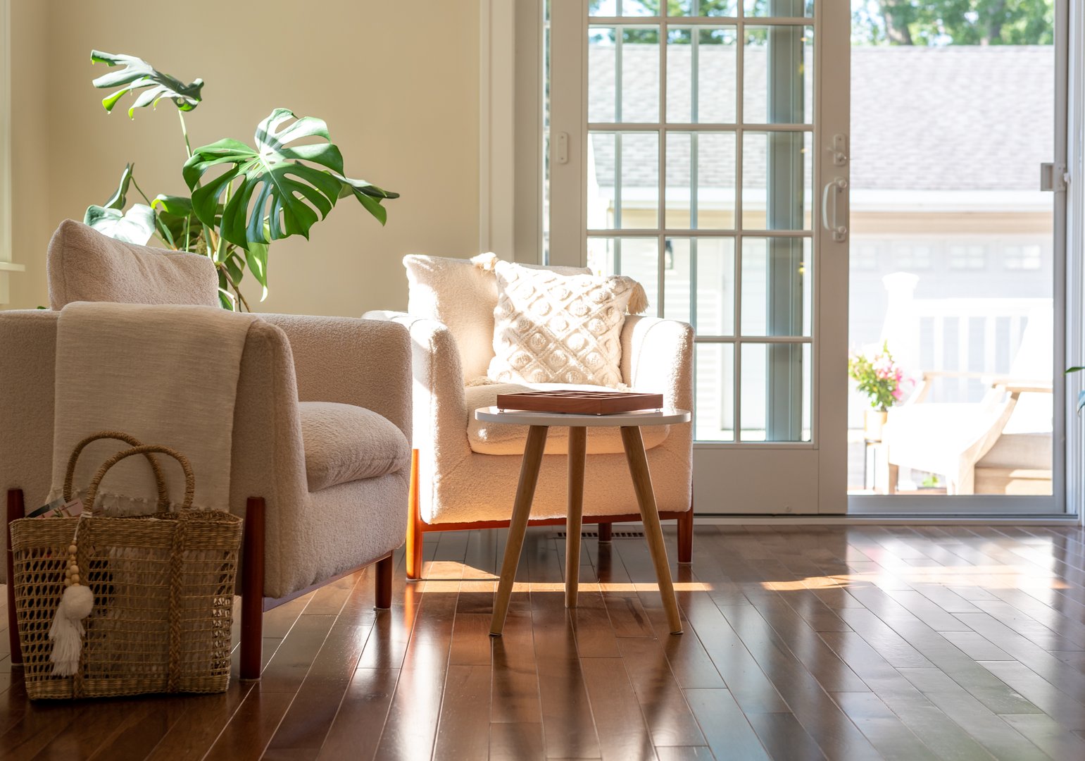Home interior with cozy chairs and houseplants in afternoon sunshine