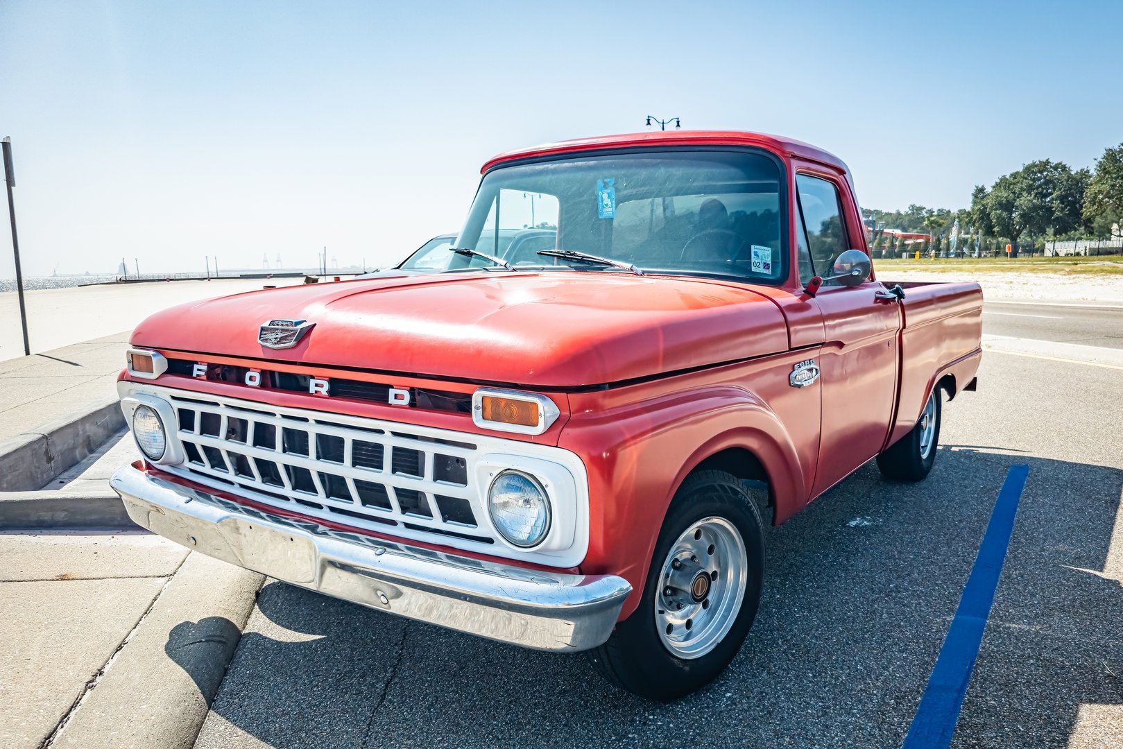 Gulfport, MS - October 03, 2023: High perspective front corner view of a 1965 Ford F100 Fleetside Pickup Truck at a local car show.