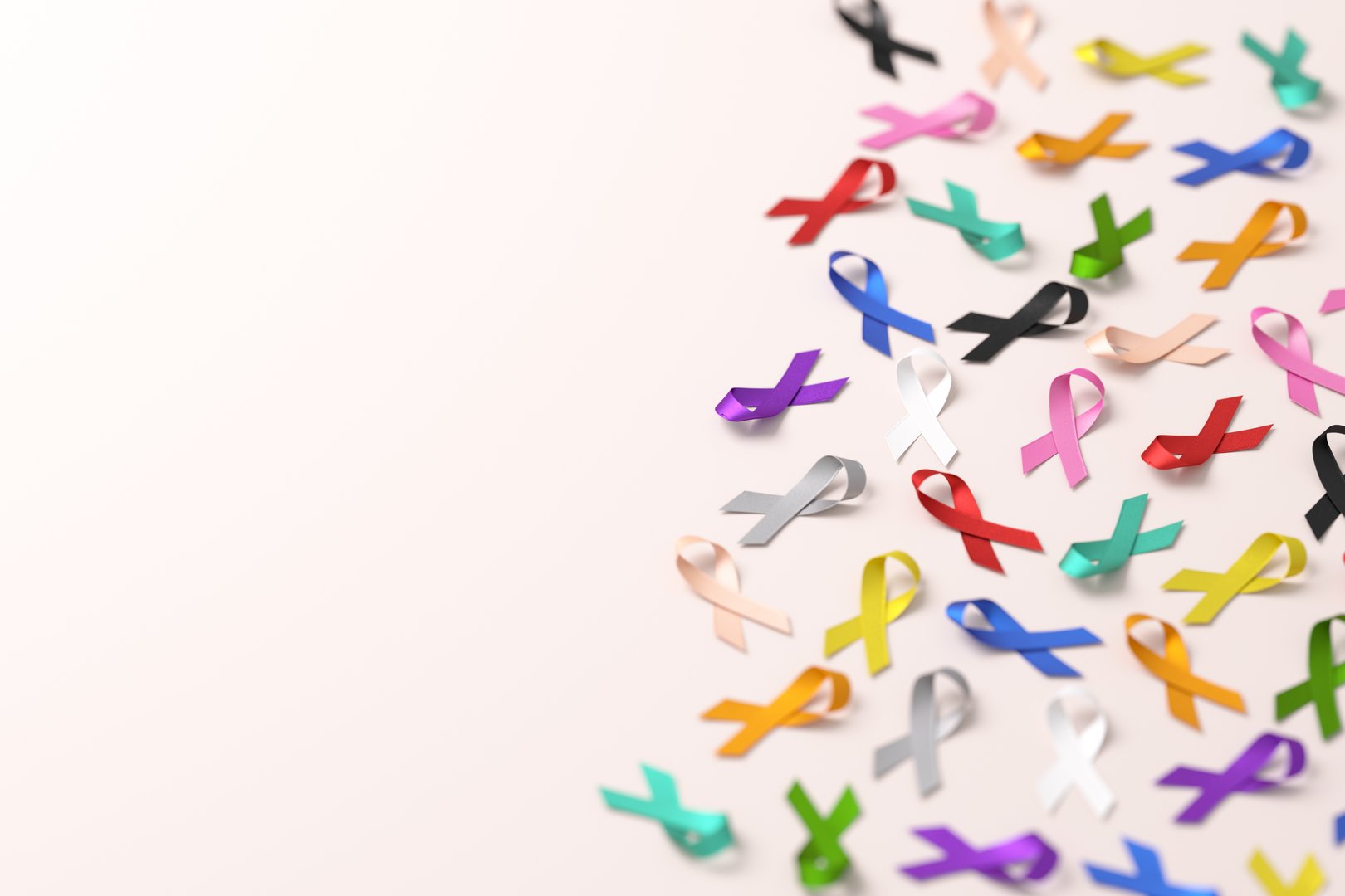 World Cancer Day banner design with colorful ribbons for different types of cancer on a background and copy space in 3D illustration