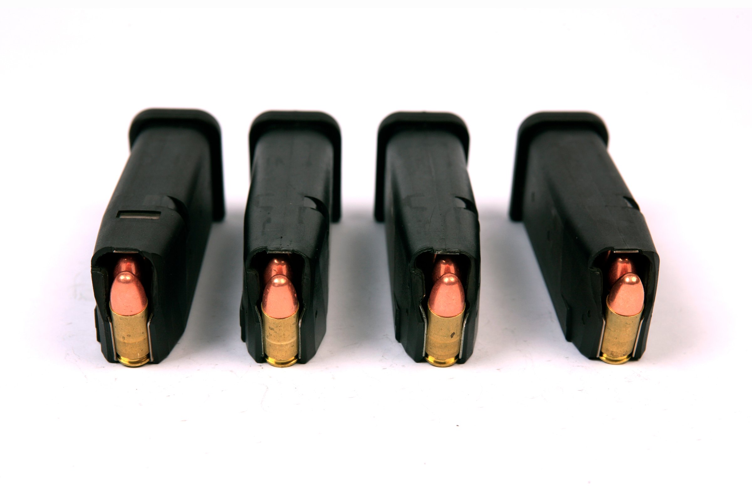 Four 9mm semi-automatic hand gun ammunition clips fully loaded with 15 rounds