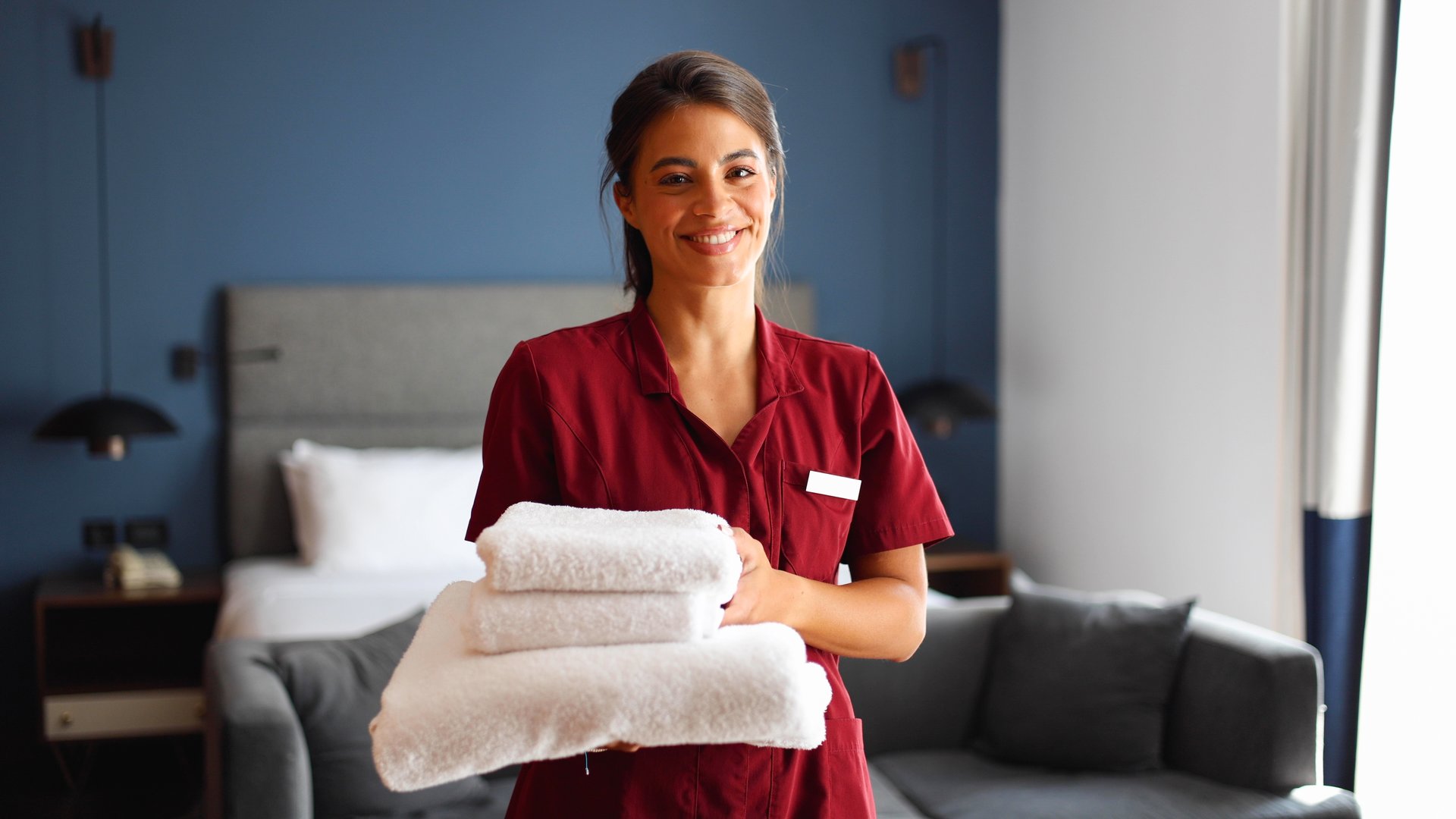Portrait of a beautiful, young maid working at the hotel