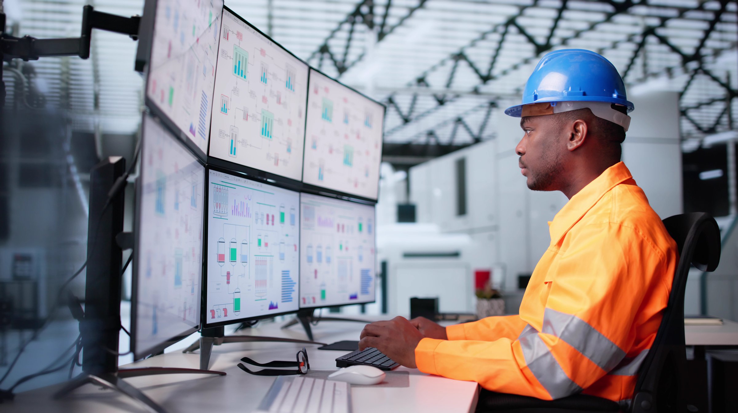 Maintenance Engineer Troubleshooting SCADA System In Modern Factory Facility. Young African-American Man