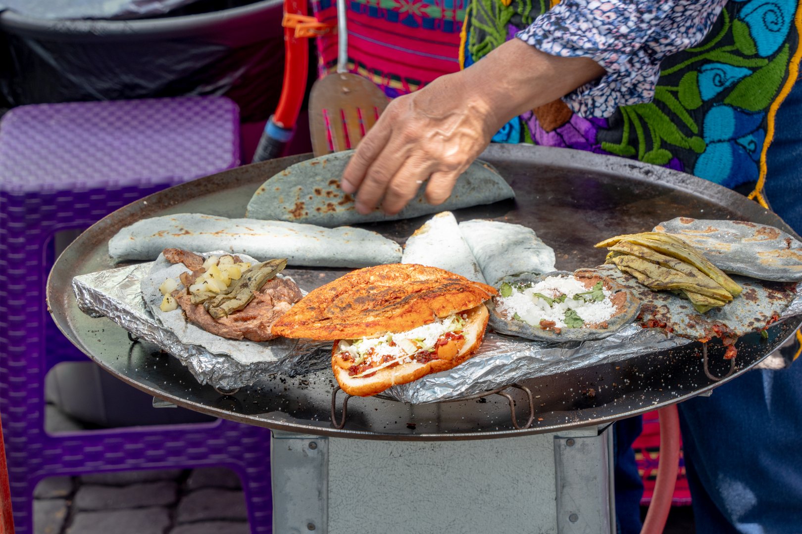 Quesadillas, Pambazos, Tlacoyos in a comal, Mexican food.