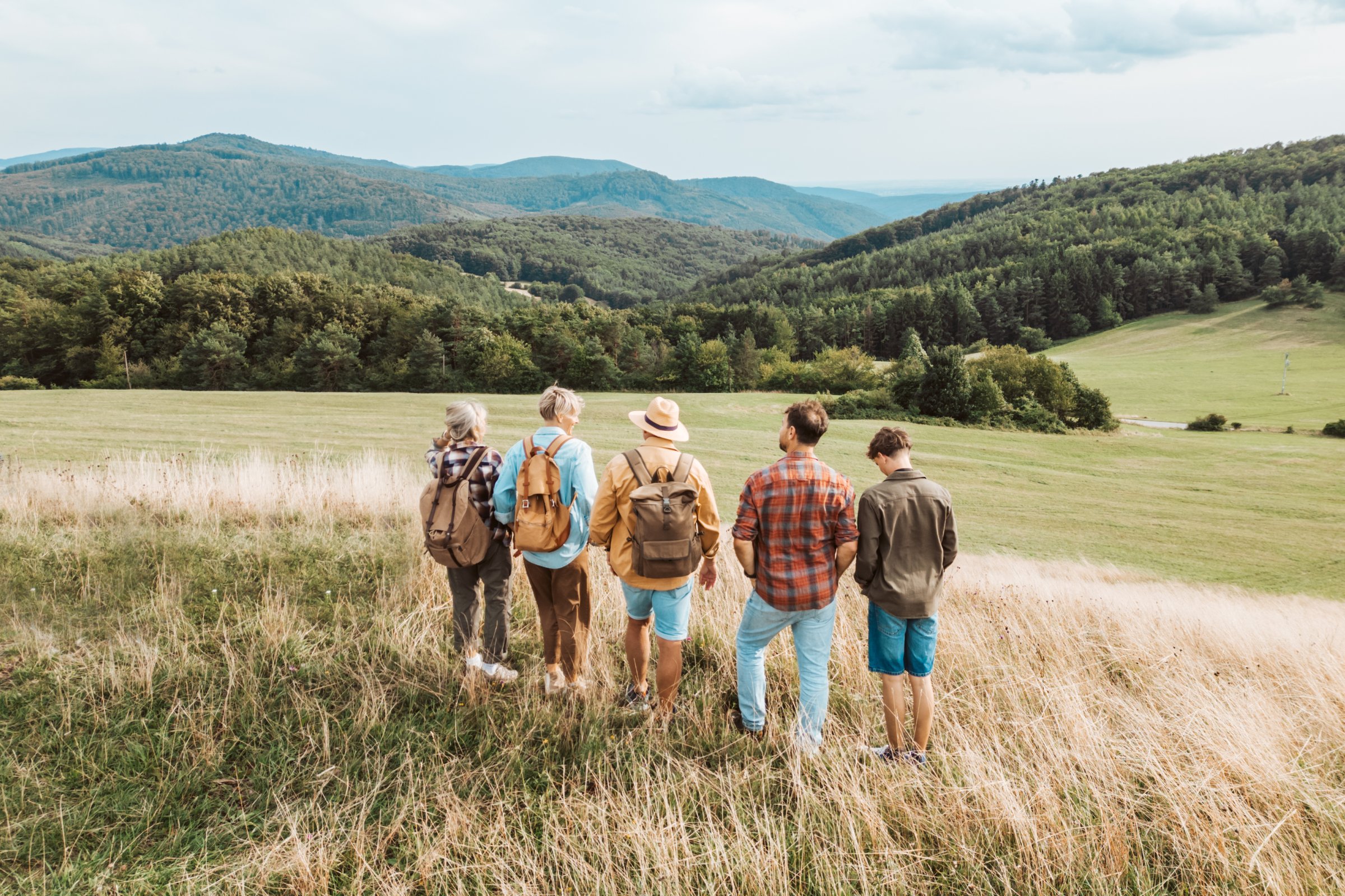 Aerial view of multigenerational family on hiking trip in the nature, rear view.
