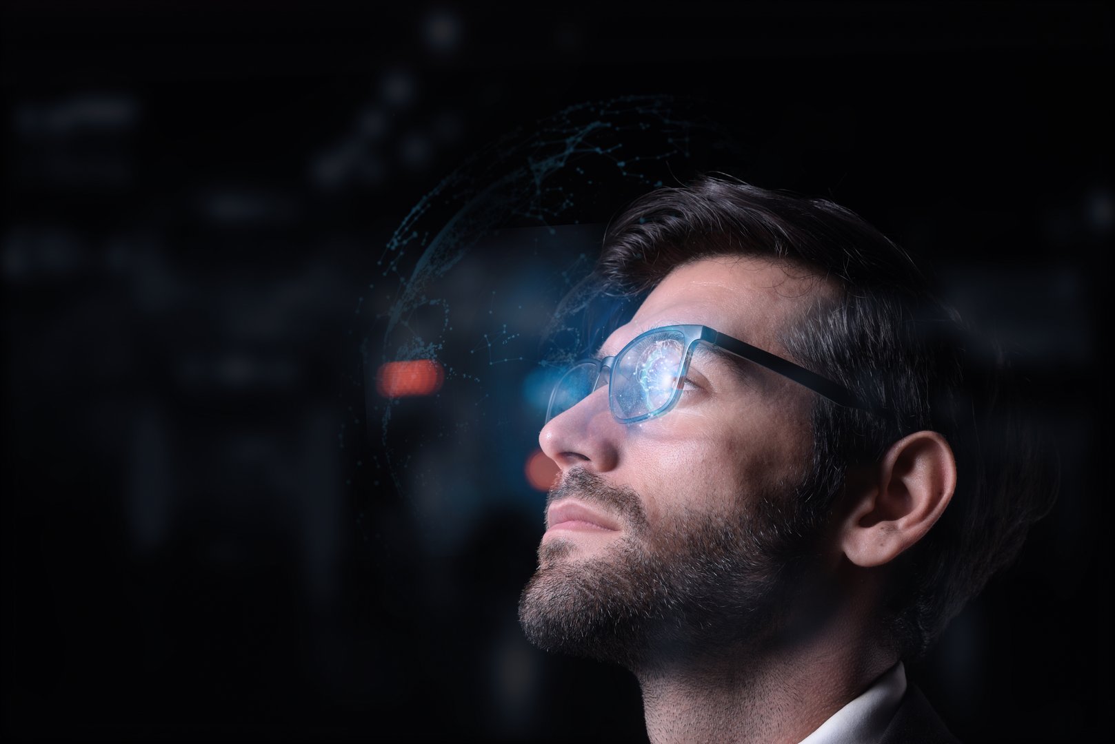 Working on a computer, a focused developer looks at programming code, data, cyber security, and digital technology while wearing glasses and producing software.