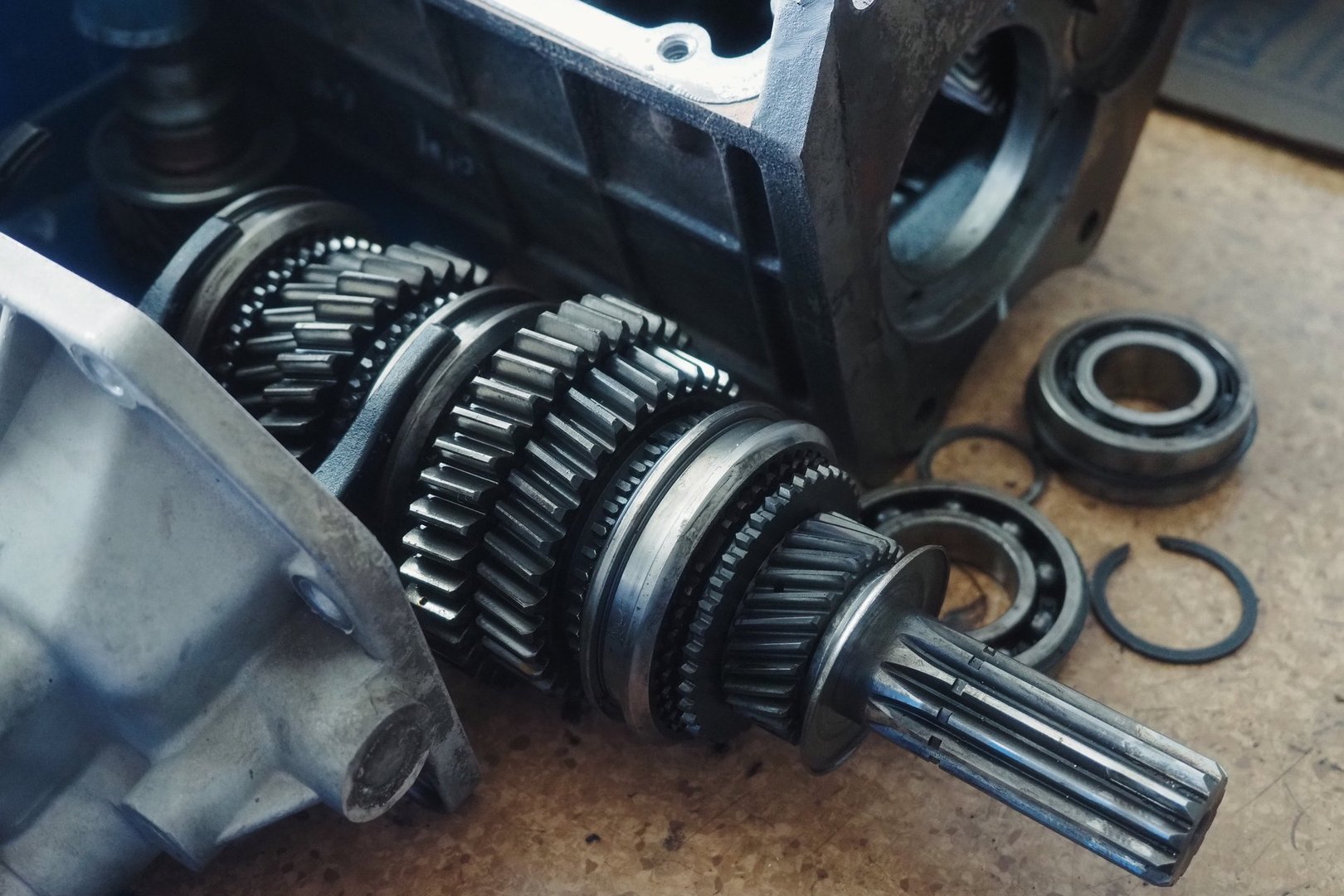 Gear spare part for car lies on workbench. Gears and transfer case. equipment repair.