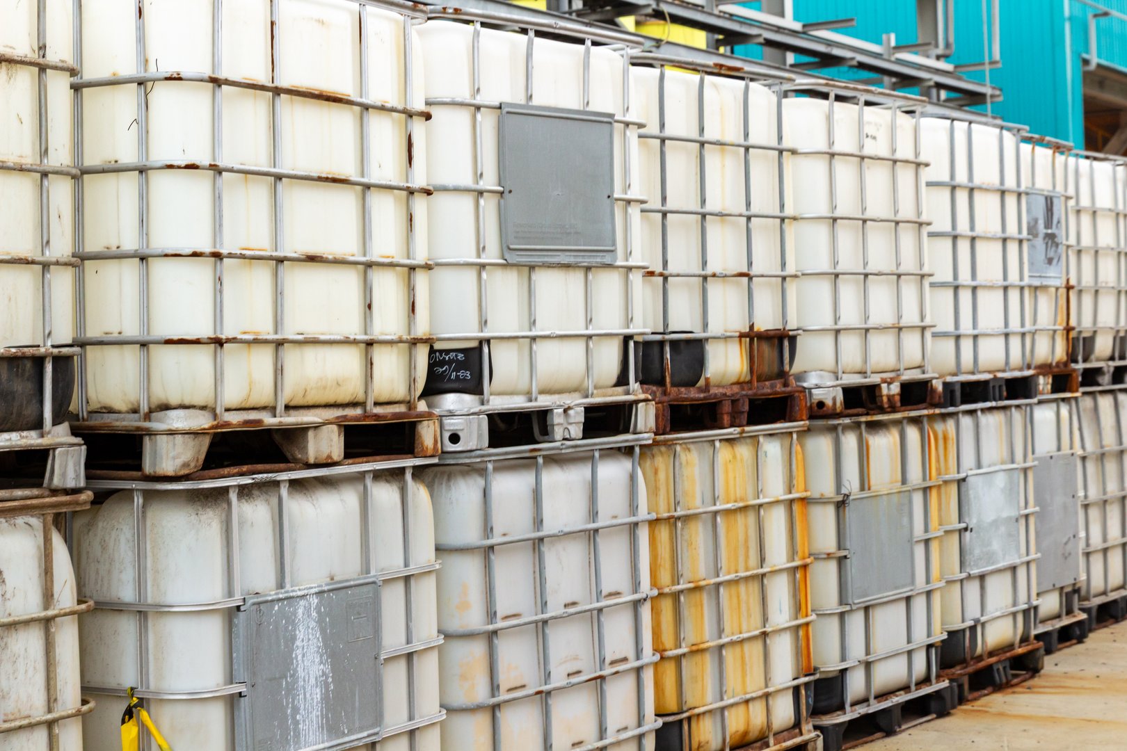 Stacked intermediate bulk containers show industrial storage and containerization system.