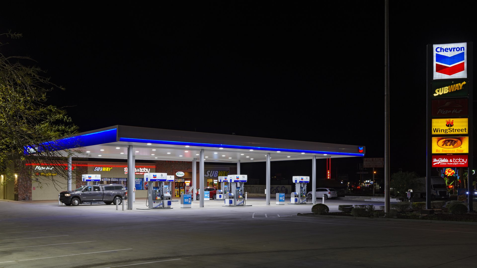 Chevron gas station shown at night in Baker, California, United States.