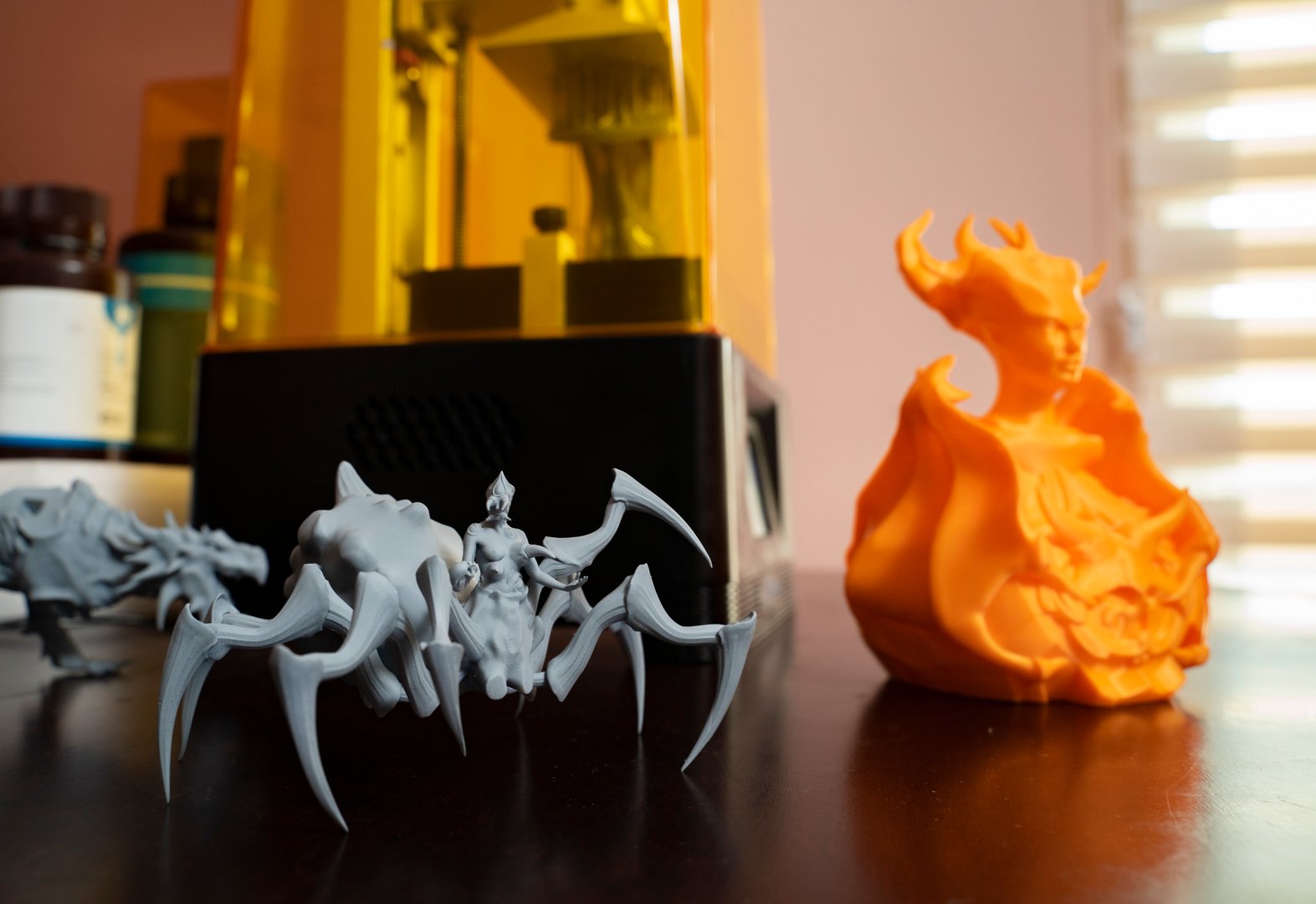 Spider abstract plastic figurine in front of 3d printer, 3d printing concept