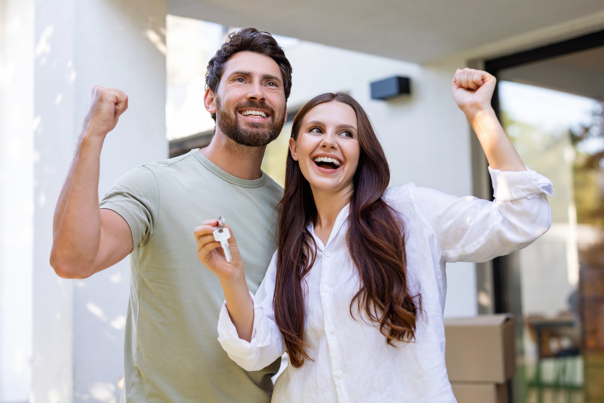 Moving. Happy couple looking excited while moving to a new house