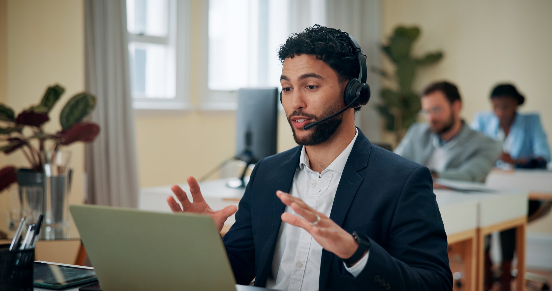 Businessman, talking and headset with laptop in office, consultant and customer service for sales. Coworking, call center and agent with advice for telemarketing, client feedback and tech for support