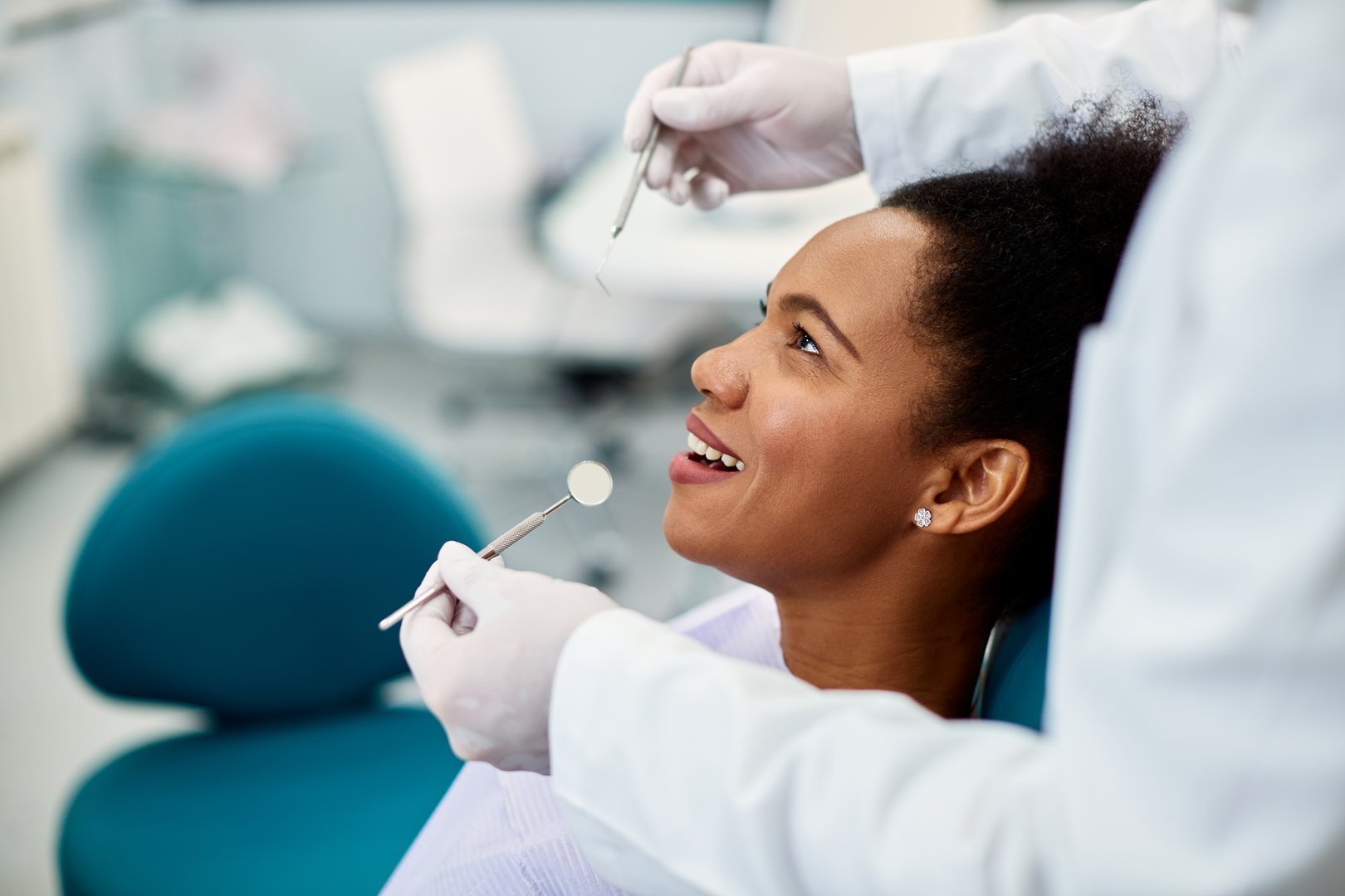 Happy black woman having dental health examination at dentist office