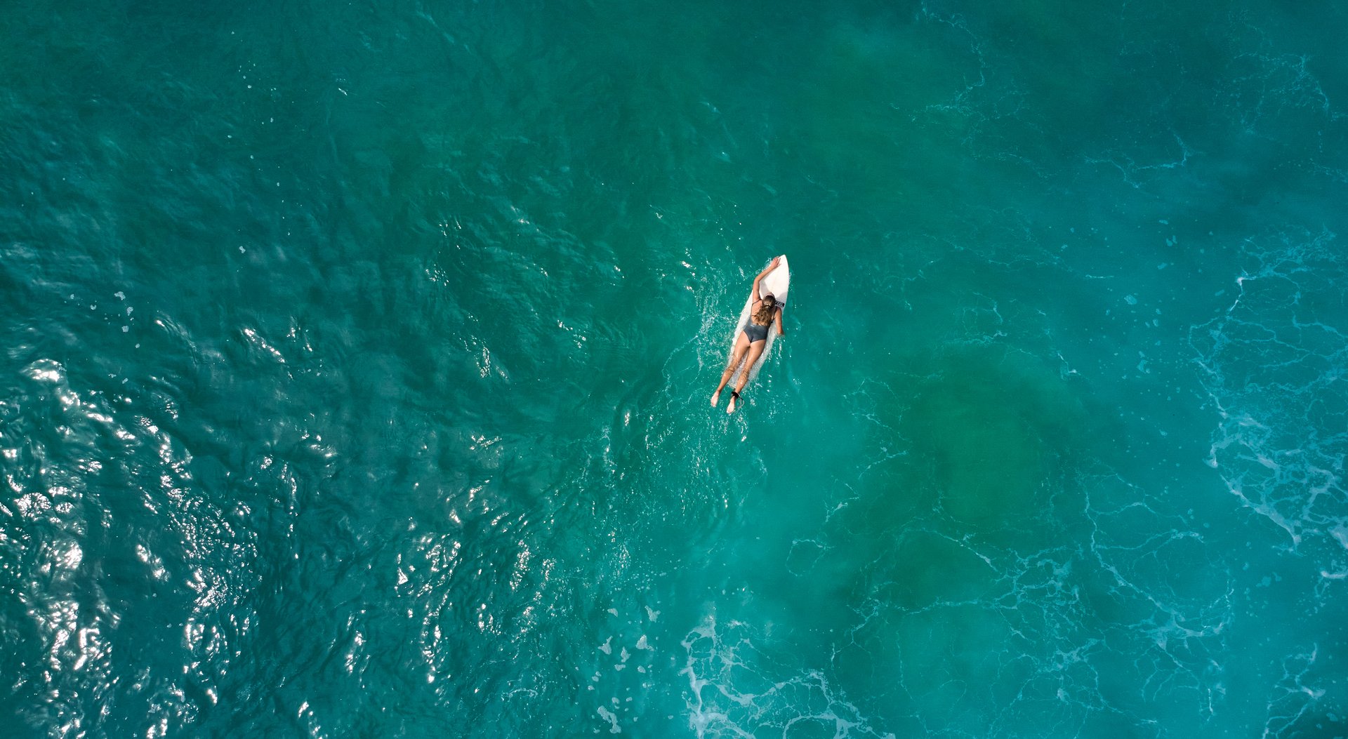 Aerial view of surfer girl in Midigama, Sri Lanka