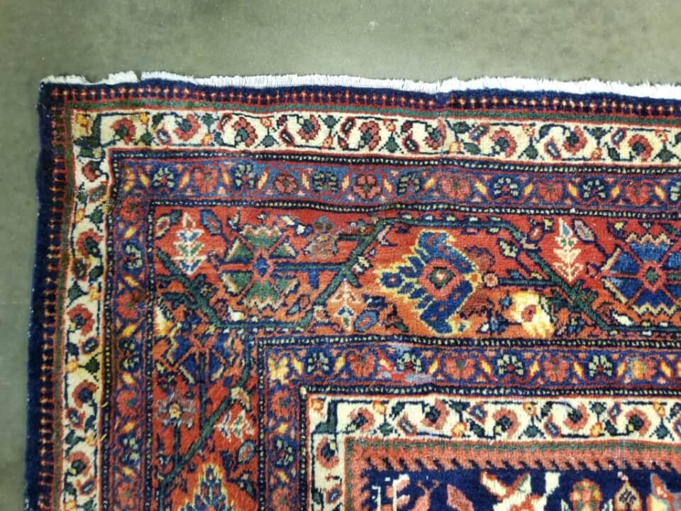 After: Professional rug damage repair with seamless pattern matching