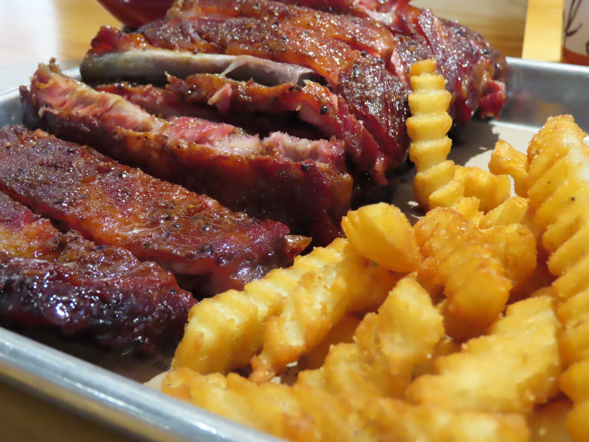 Delicious pork ribs dipped in BBQ sauce