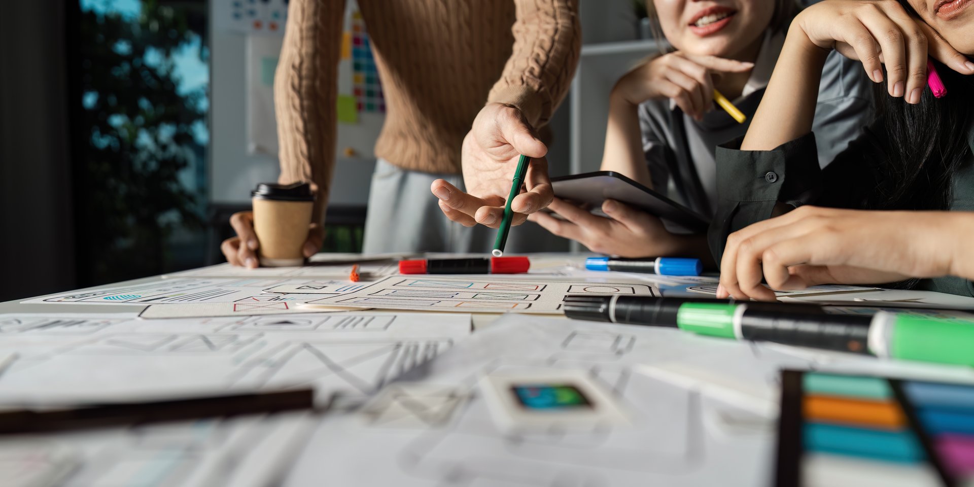 Designers engaged in a dynamic UX/UI brainstorming session, focusing on creative digital solutions and user experience improvements.