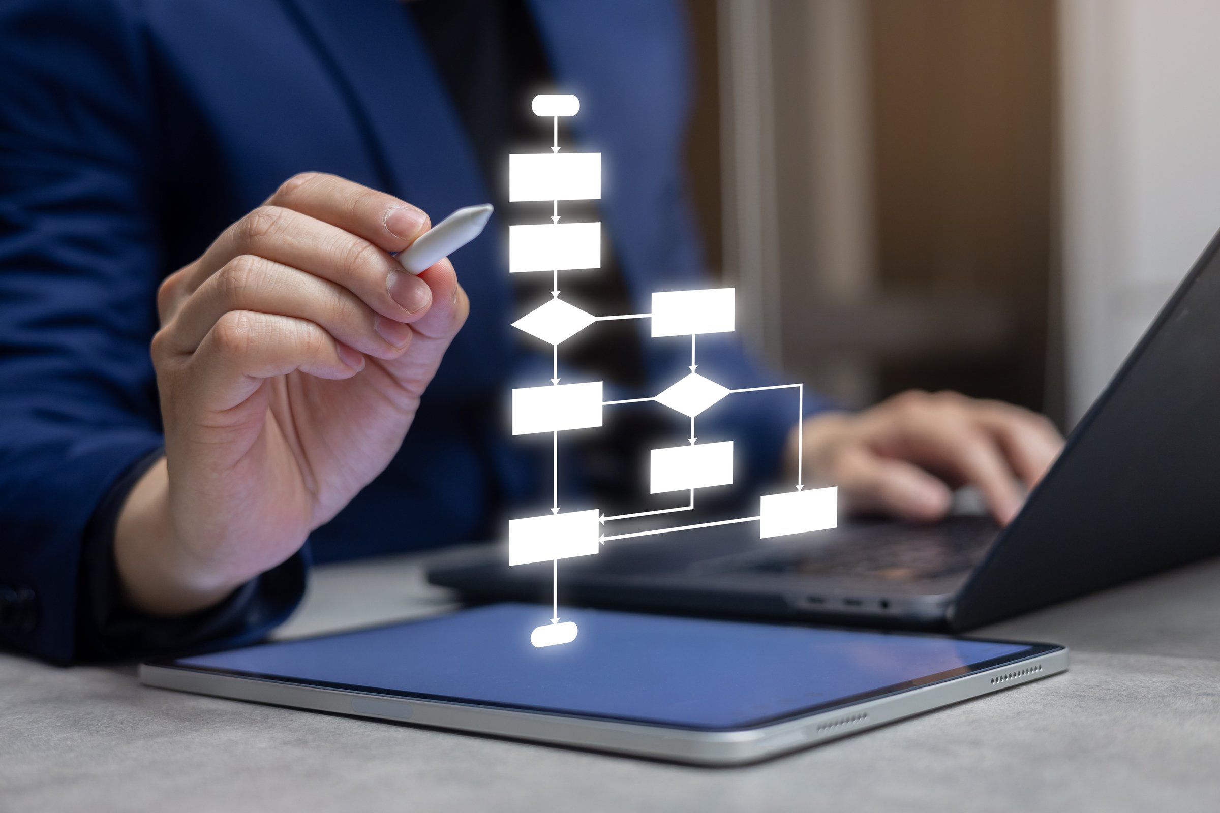 close up entrepreneur businessman hand use stylus pen to write and check about progress or procedure of strategy and resolving with virtual flowchart diagram for business planning and performance concept