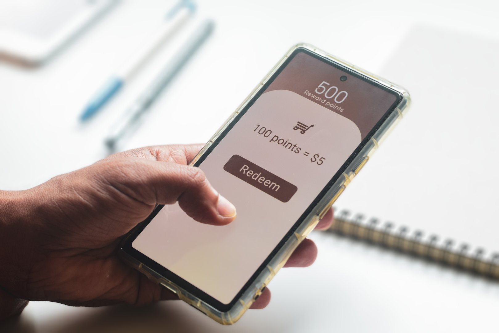 A man trying to transfer redeem rewards points into cash on his mobile phone. Loyalty programs to increase customer engagement in digital marketing concepts. Selective focus.