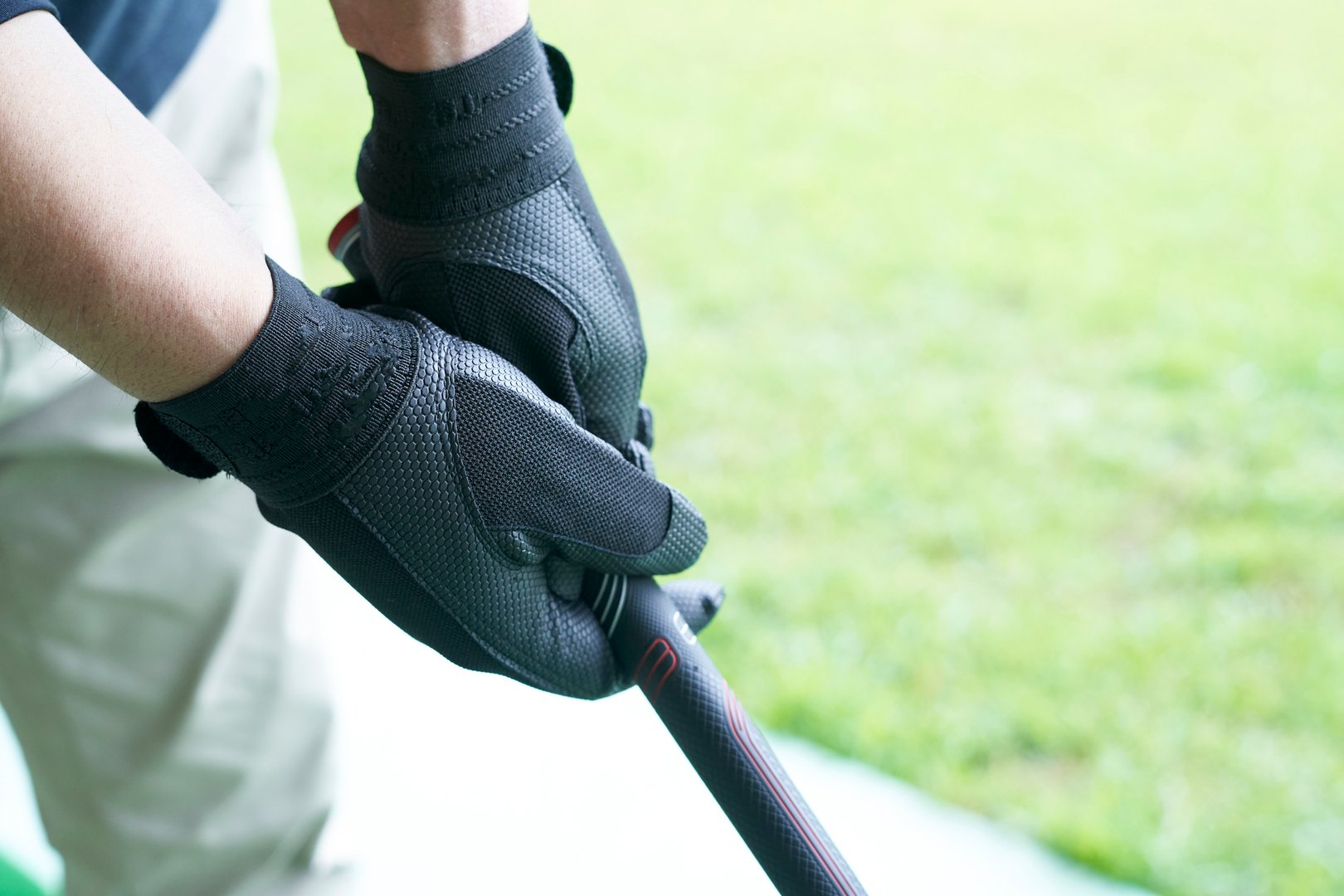 Hand of senior man practicing on golf course