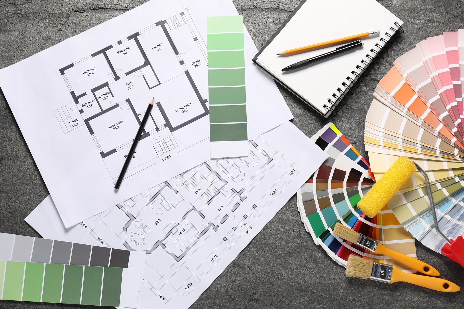 House plans and different decorator's tools on grey table, flat lay