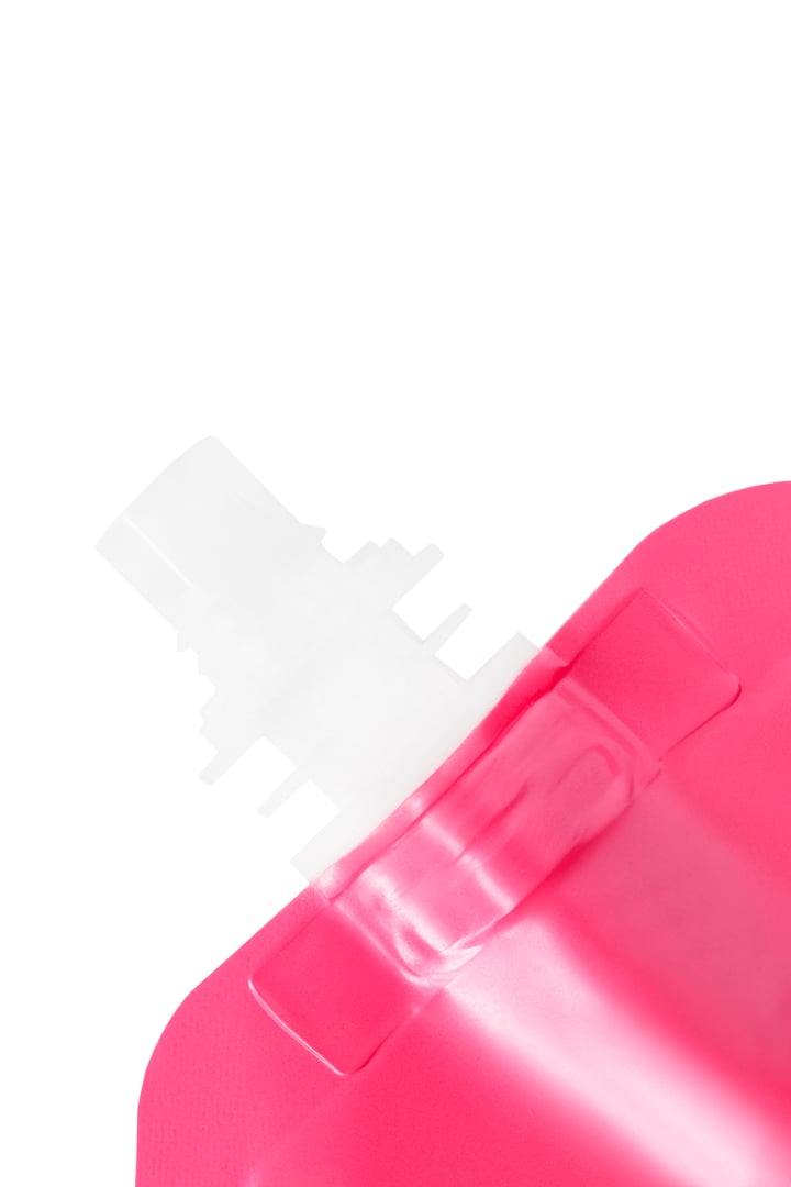 Pink plastic spout pouch pack closeup isolated over white