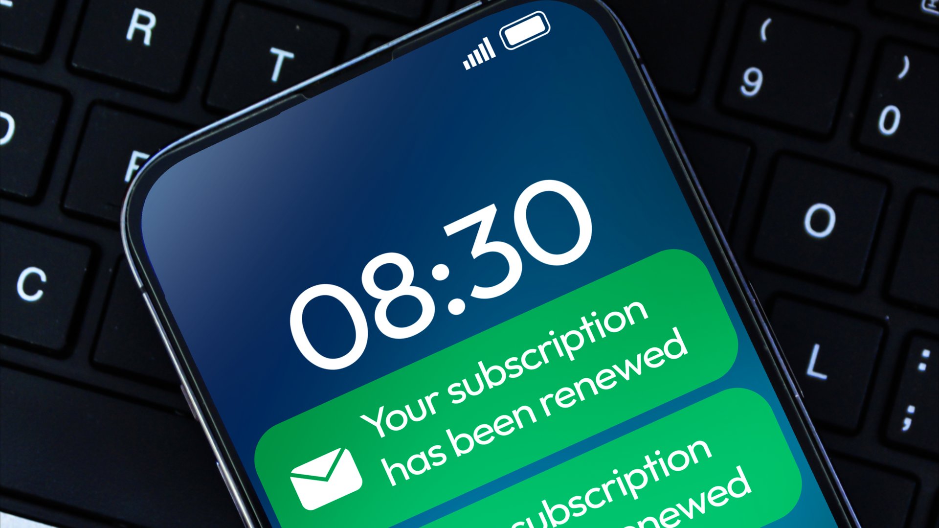 Subscription Renewal message notification in green color on the smartphone screen close up background