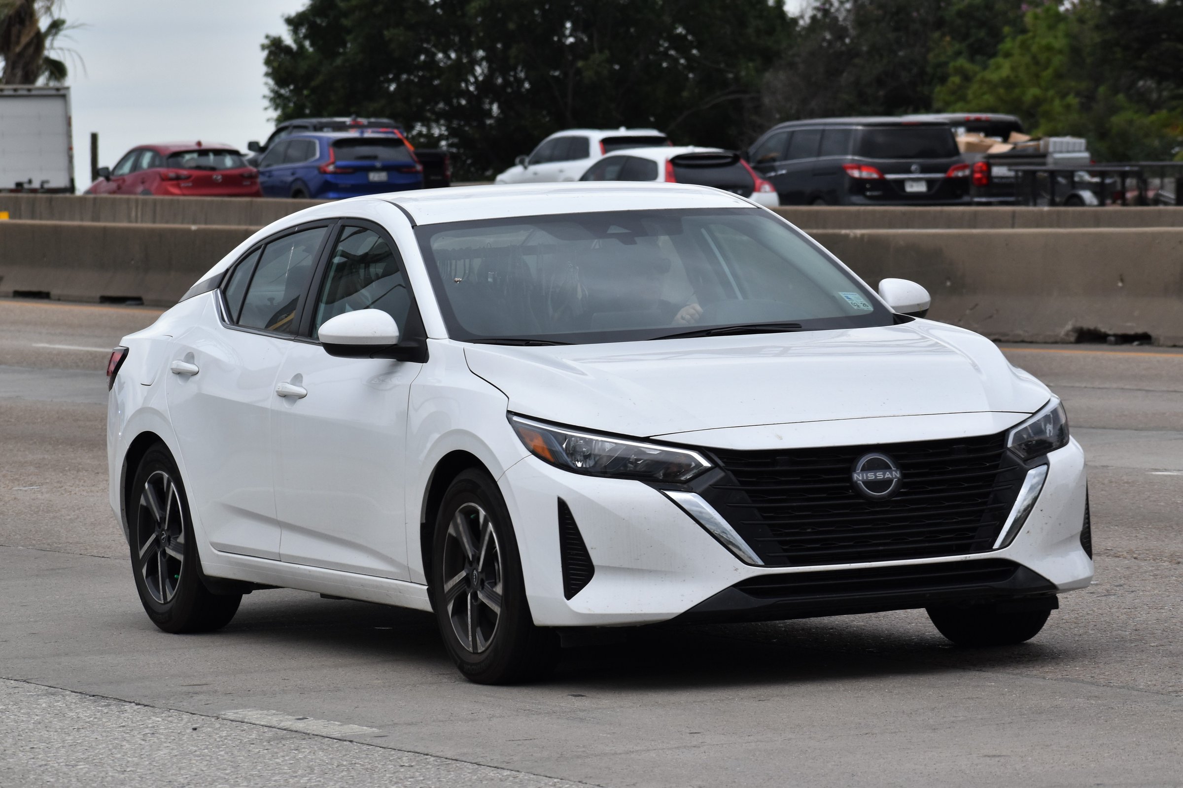 Houston, TX USA - 5/11/2024 - A portrait of a Nissan Altima sedan traveling down a highway in moderate traffic