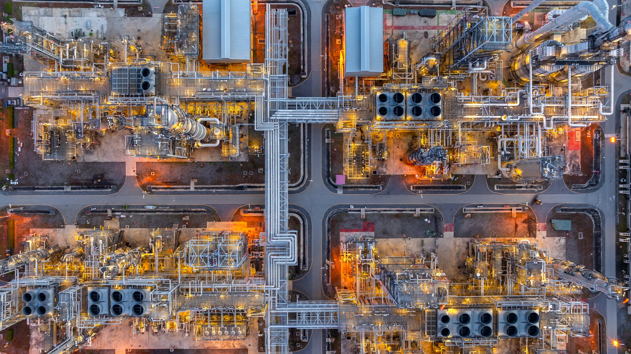 Aerial view oil and gas refinery plant at night, Top view oil and gas refinery, Oil and gas refinery petrochemical industrial, Petrochemical refinery industrial energy supply chain.