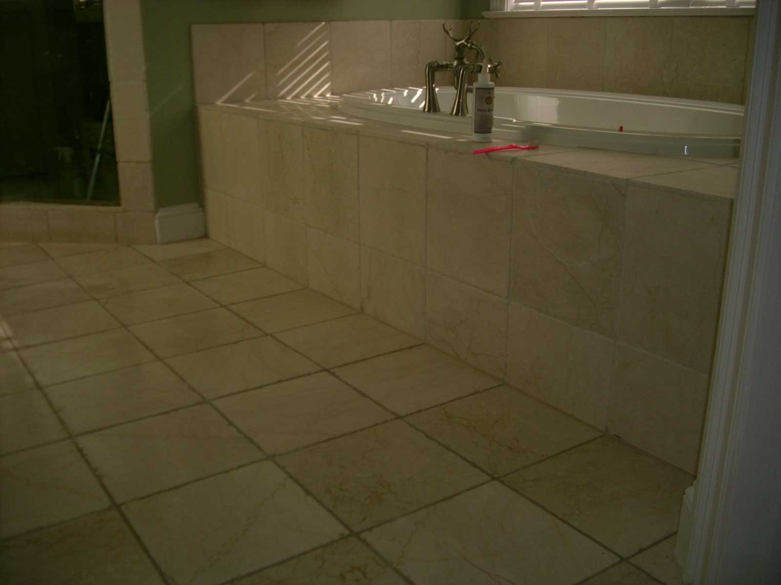 Tub and floor before grout restoration
