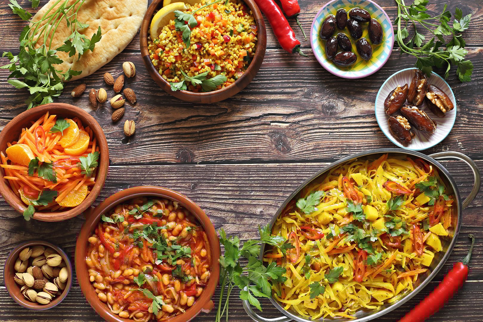 Traditional African dishes assortment. Chakalaka, Ethiopian Cabbage, Couscous salad, Carrot and citrus fruits salad. Selective focus