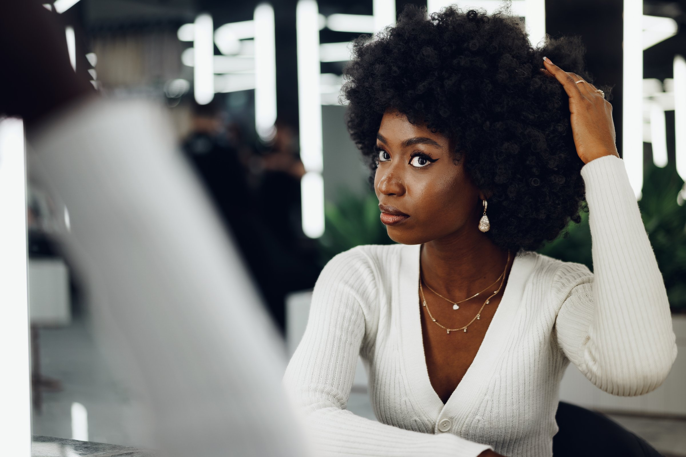 Young African woman customer getting a hairstyle at a beauty salon