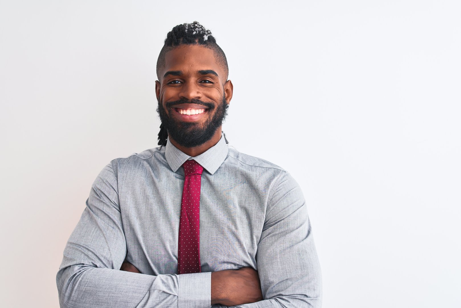 African american businessman with braids wearing tie standing over isolated white background happy face smiling with crossed arms looking at the camera. Positive person.