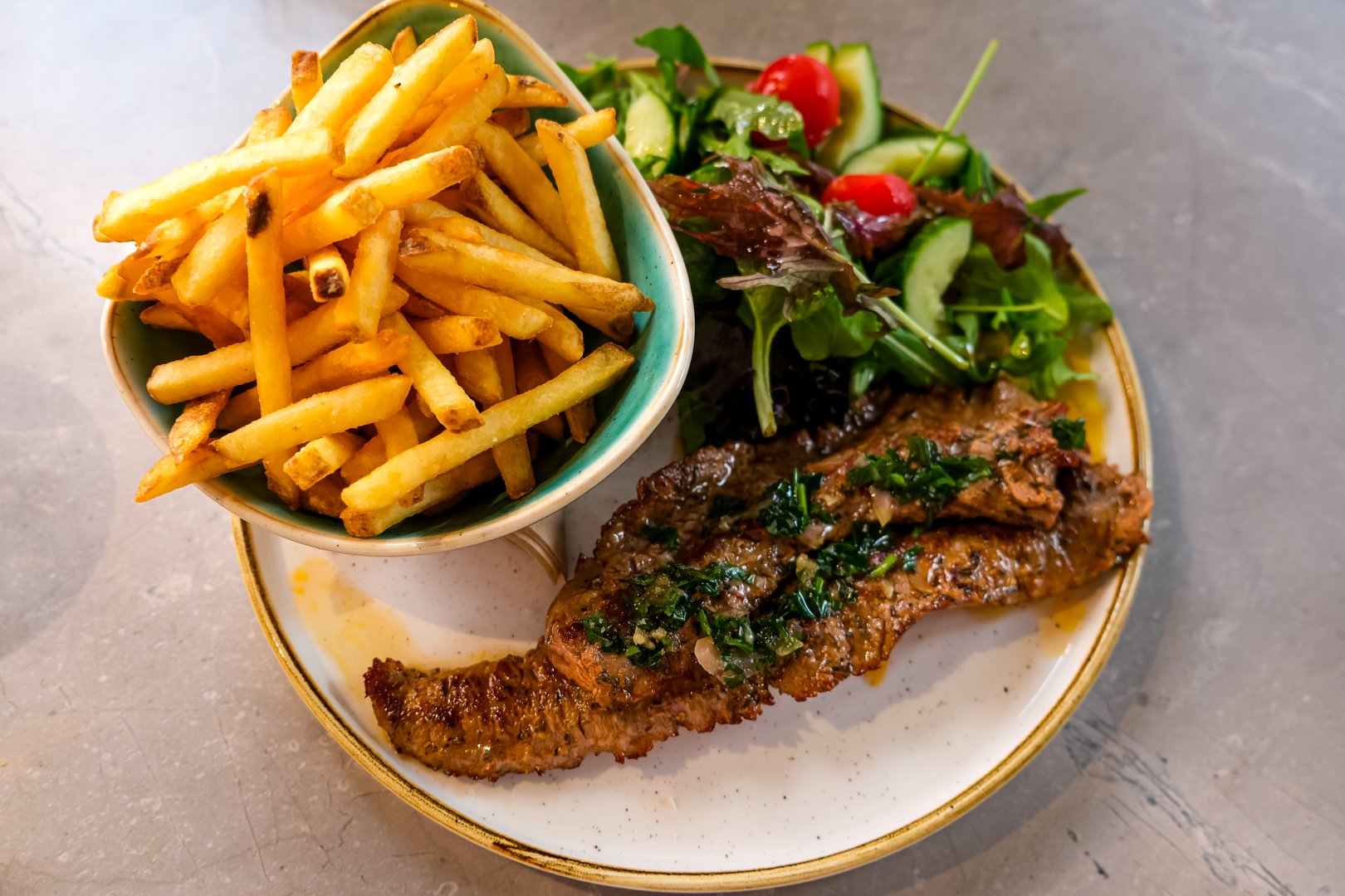 Skirt steak with salad and fries. With chimichurri sauce. Healthy meal