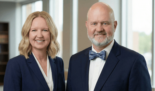 Elderly man in wheelchair with caregiver