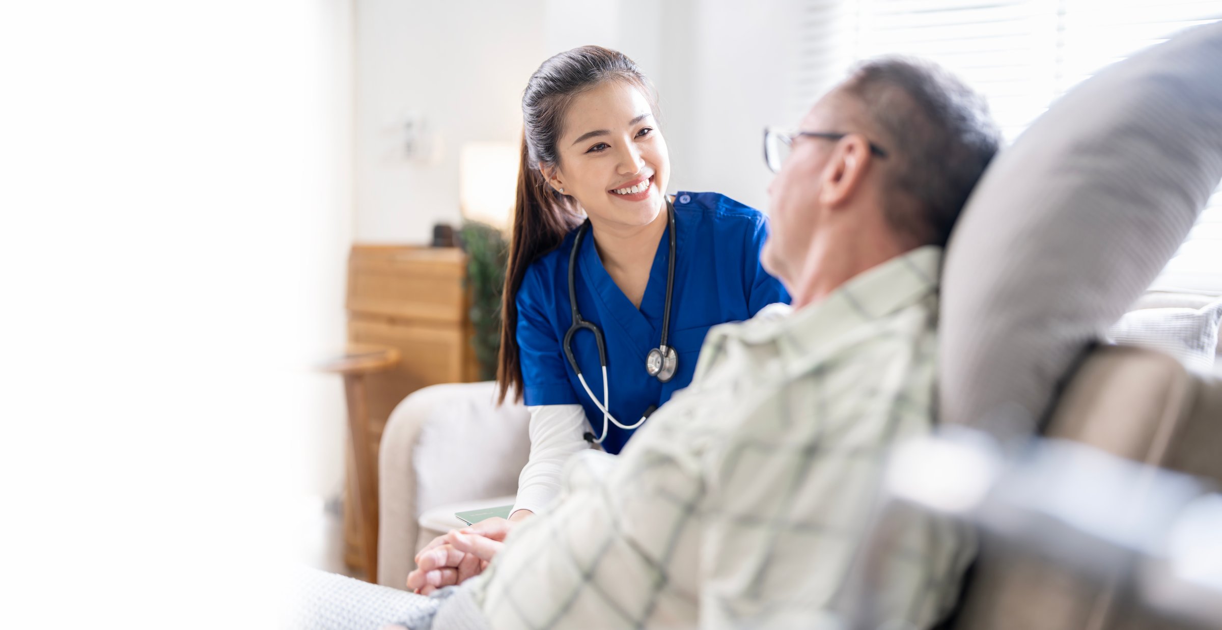 Young female doctor talking with her Elderly male patients to encourage in nursing home