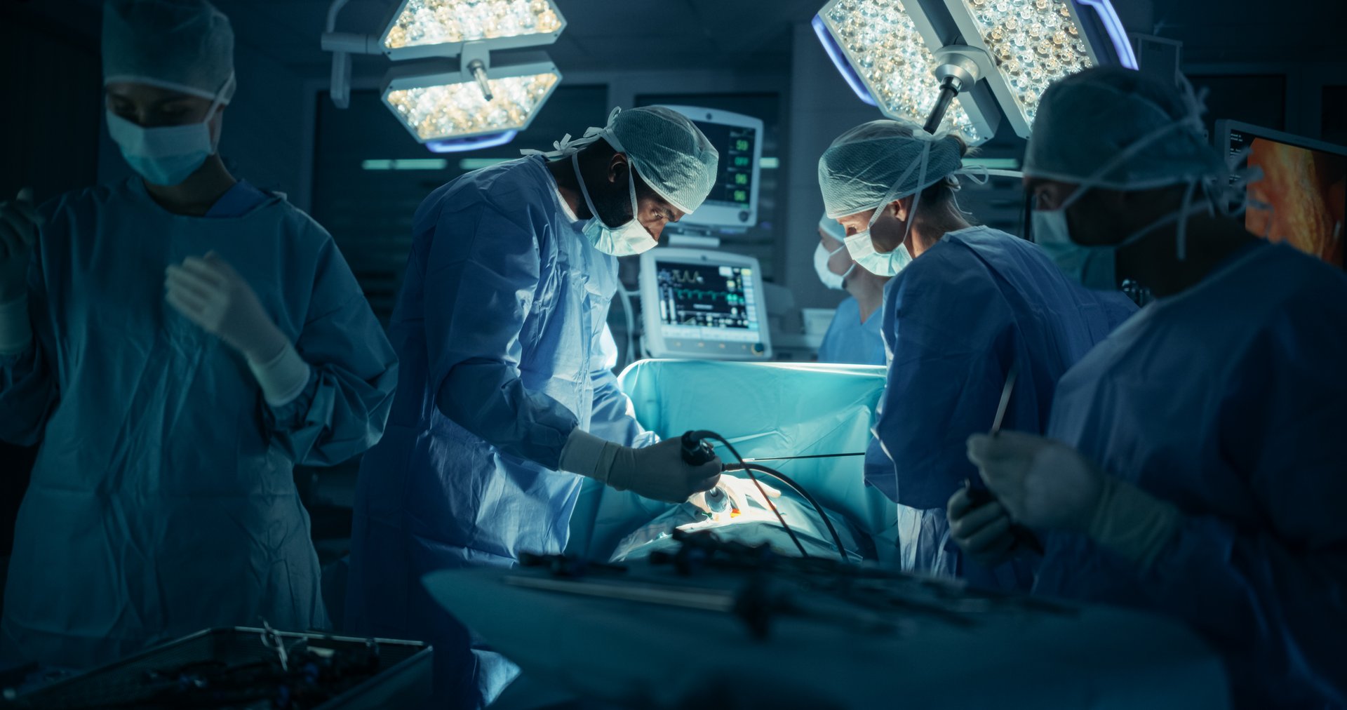 Deep in the Process of an Emergency Surgery, Diverse Team of Healthcare Professionals Navigating Each Stage of the Operation with Extreme Concentration, Uniting Their Skills to Perform the Procedure