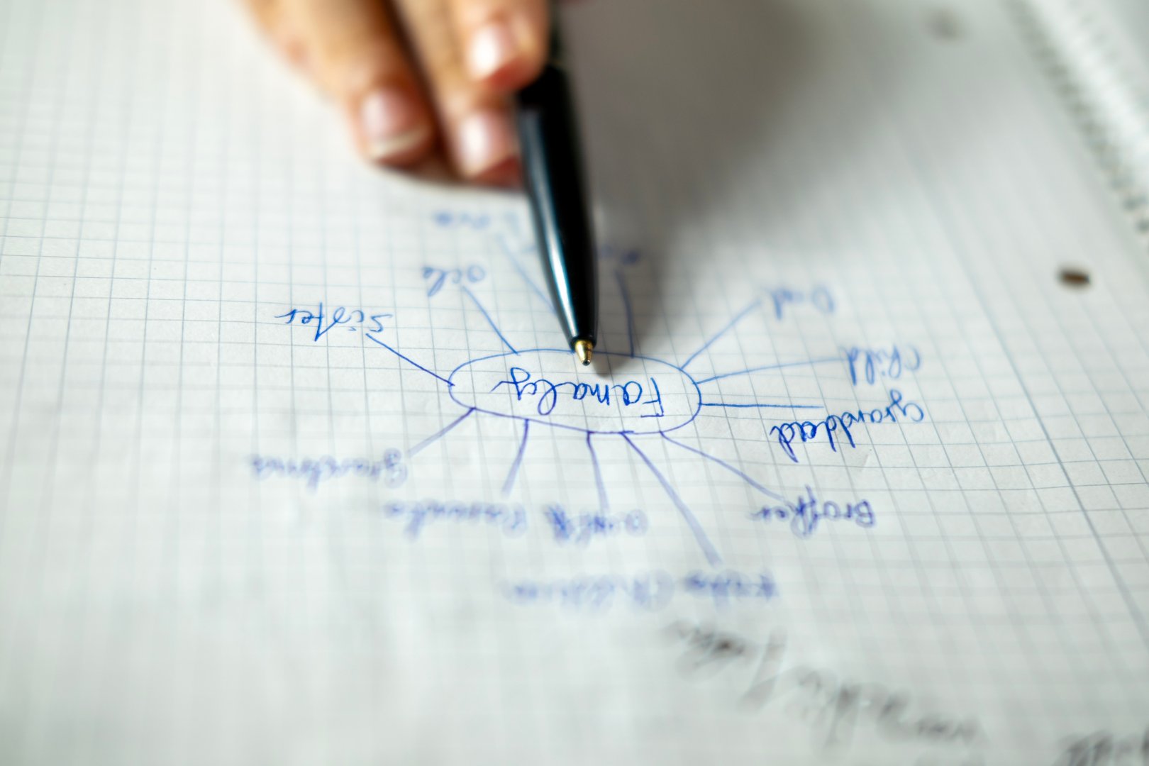 teenage boy draws family mind map relatives, DNA, and genealogy, sketches family tree, trust and generational bonds, child's hands write, sketches ideas on graph paper, productivity learning
