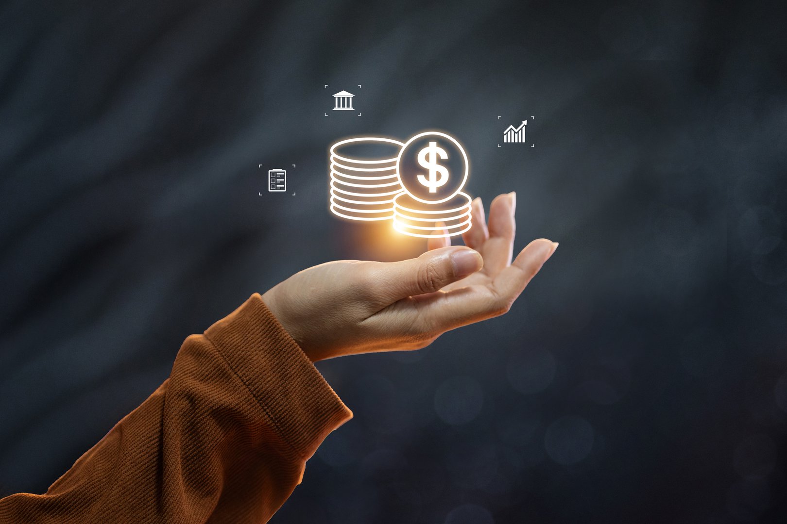 A hand holding a glowing icon of stacked coins, representing digital banking, savings, and financial wealth management.