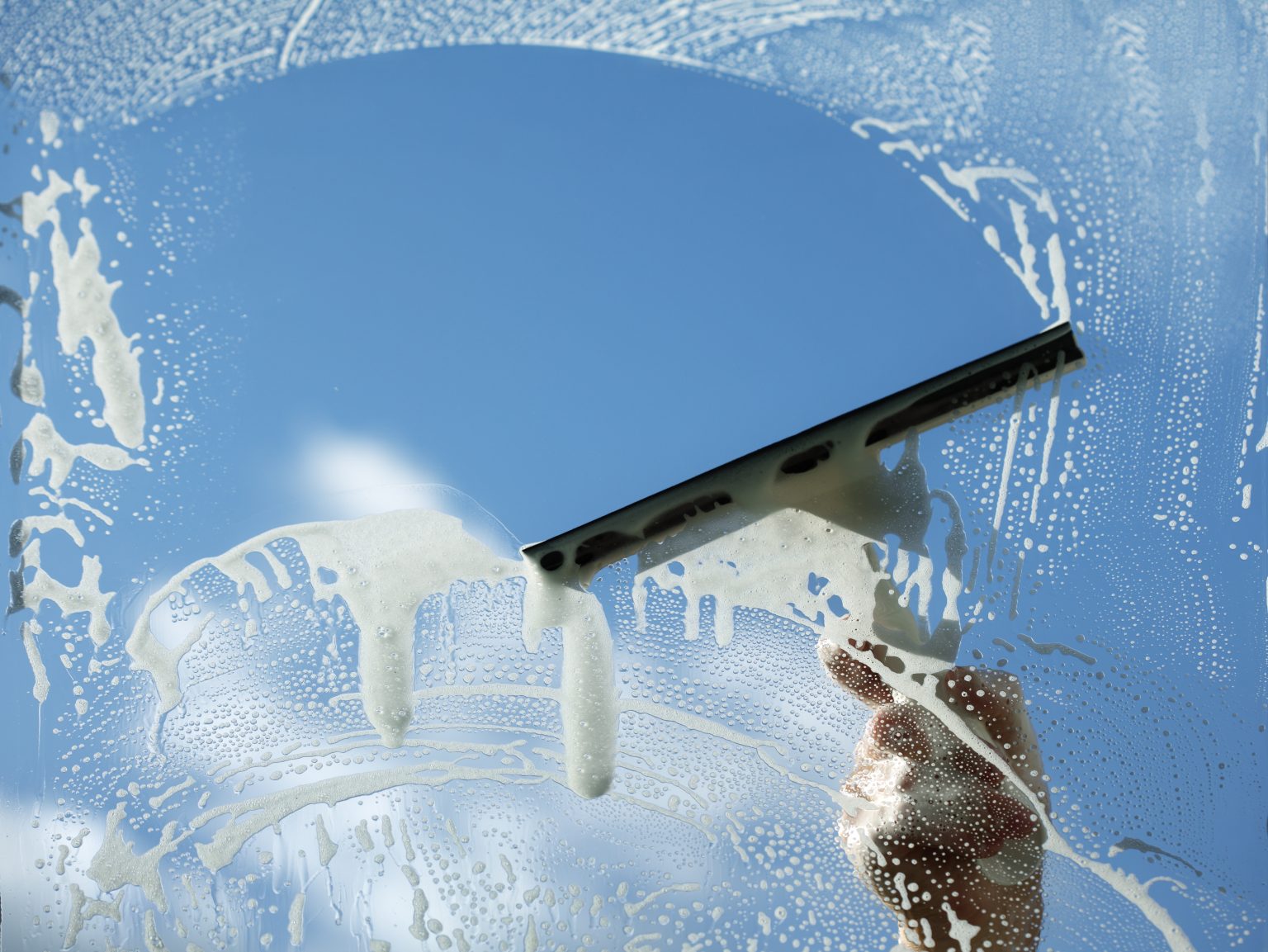Window cleaner cleaning residential house windows